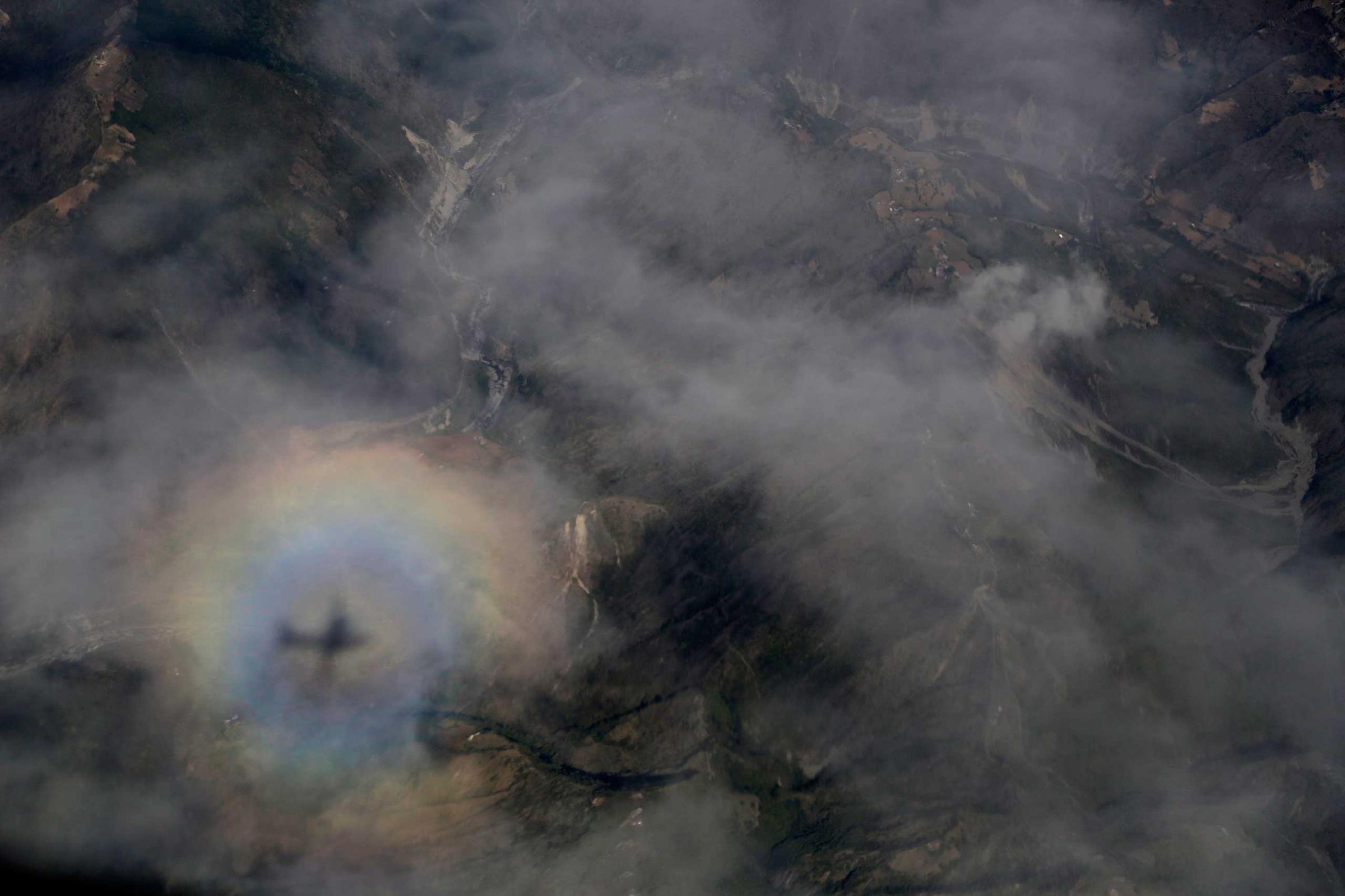 The shadow of an Indian Air Force aircraft carrying relief material is cast on clouds as it approaches landing in Kathmandu, Nepal, on April 27, 2015.