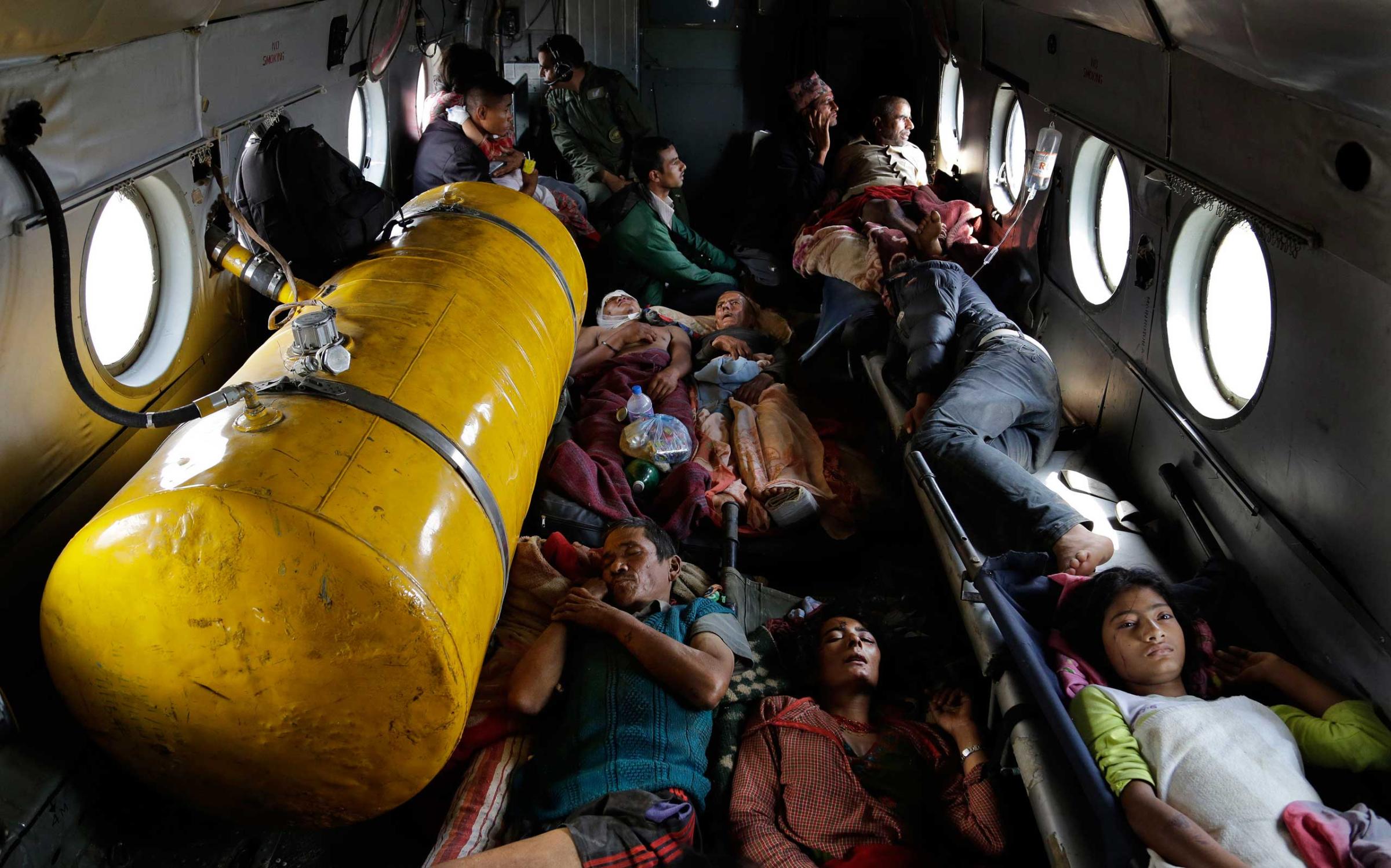 Nepalese victims of Saturday's earthquake lie inside an Indian air force helicopter as they are evacuated from Trishuli Bazar to Kathmandu airport in Nepal on April 27, 2015.