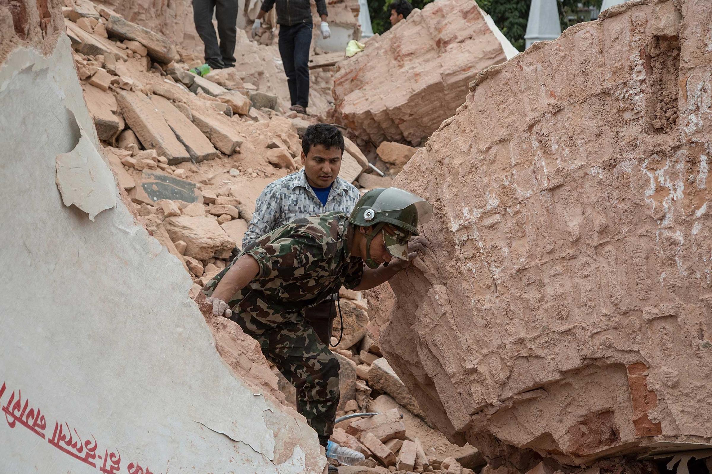 Emergency rescue workers search for survivors in the debris of Dharara tower in Kathmandu after it collapsed.