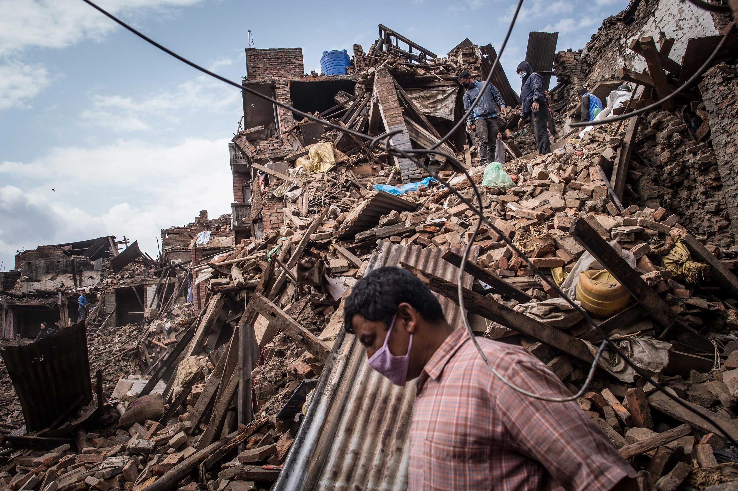 Nepalese victims of the earthquake search for their belongings among debris of their homes in Bhaktapur, Nepal, on April 29, 2015. (David Ramos—Getty Images)