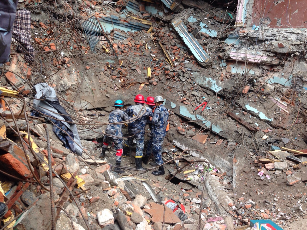 The first rescue team arriving at the scene where Pemba Tamang, 15, had been trapped for five days in Kathmandu, Nepal, April 30, 2015 (Adam McCauley for TIME)