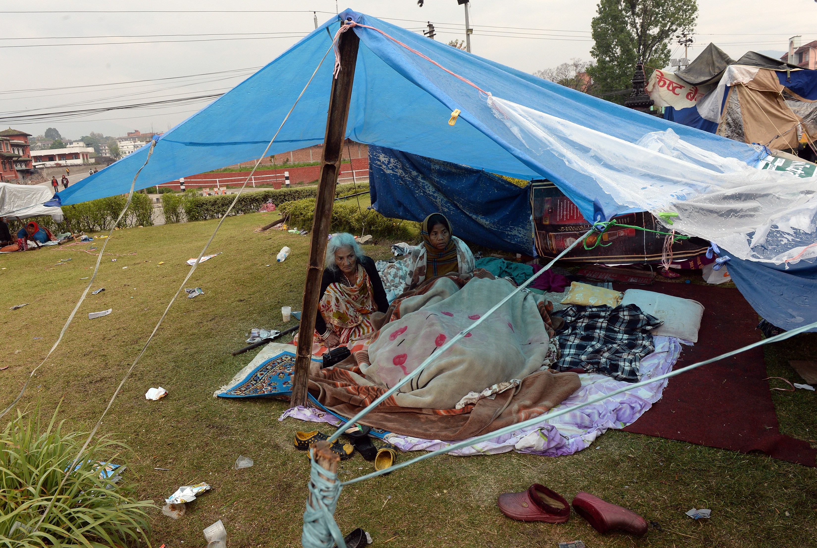 Nepalese people rest in their makeshift shelter next to a road in Kathmandu on April 27, 2015, two days after a 7.8 magnitude earthquake hit Nepal. (Prakash Singh—AFP/Getty Images)