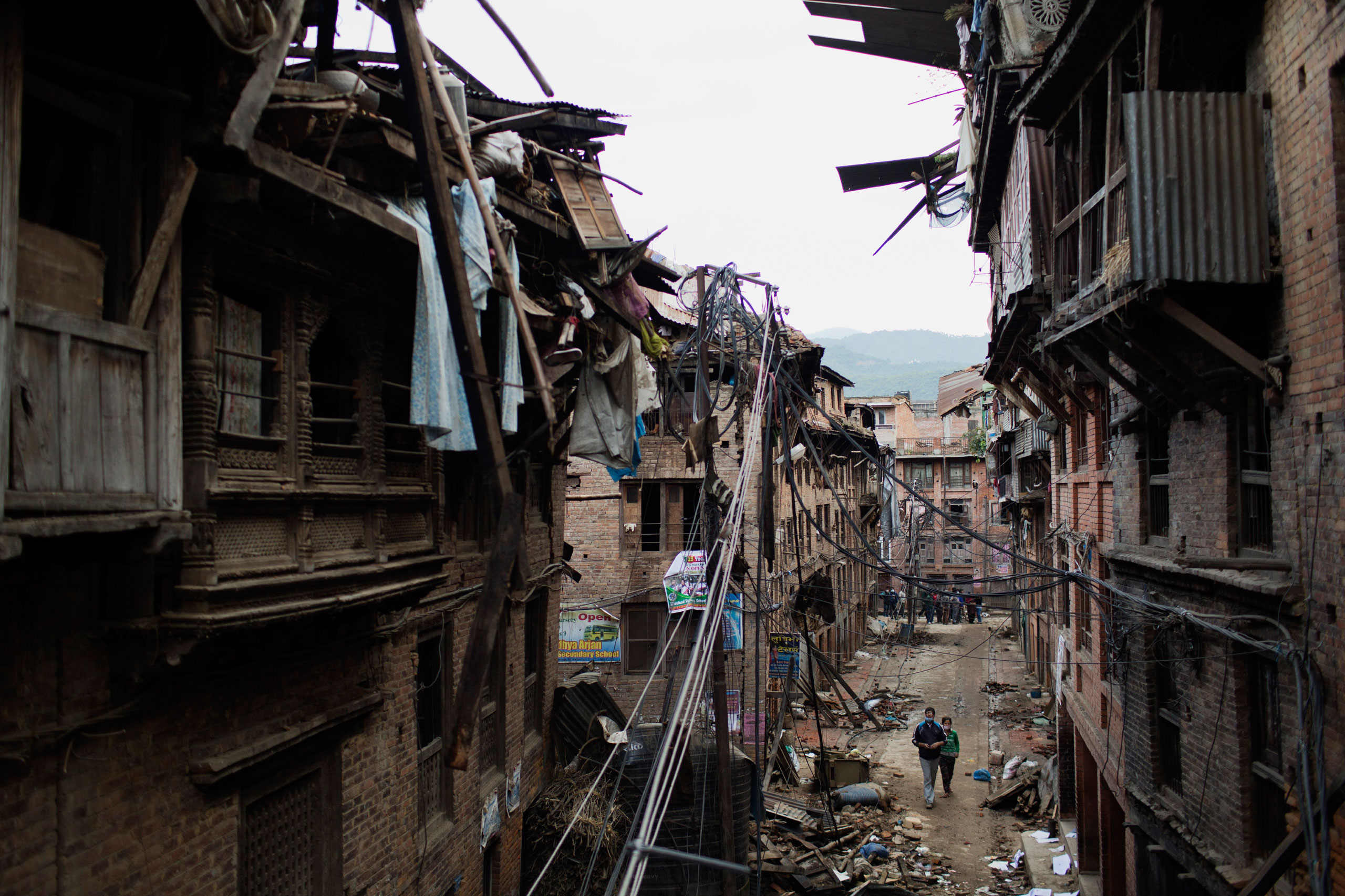 People walk through the damaged streets in the ancient city of Bhaktapur, Kathmandu Valley, April 29, 2015.