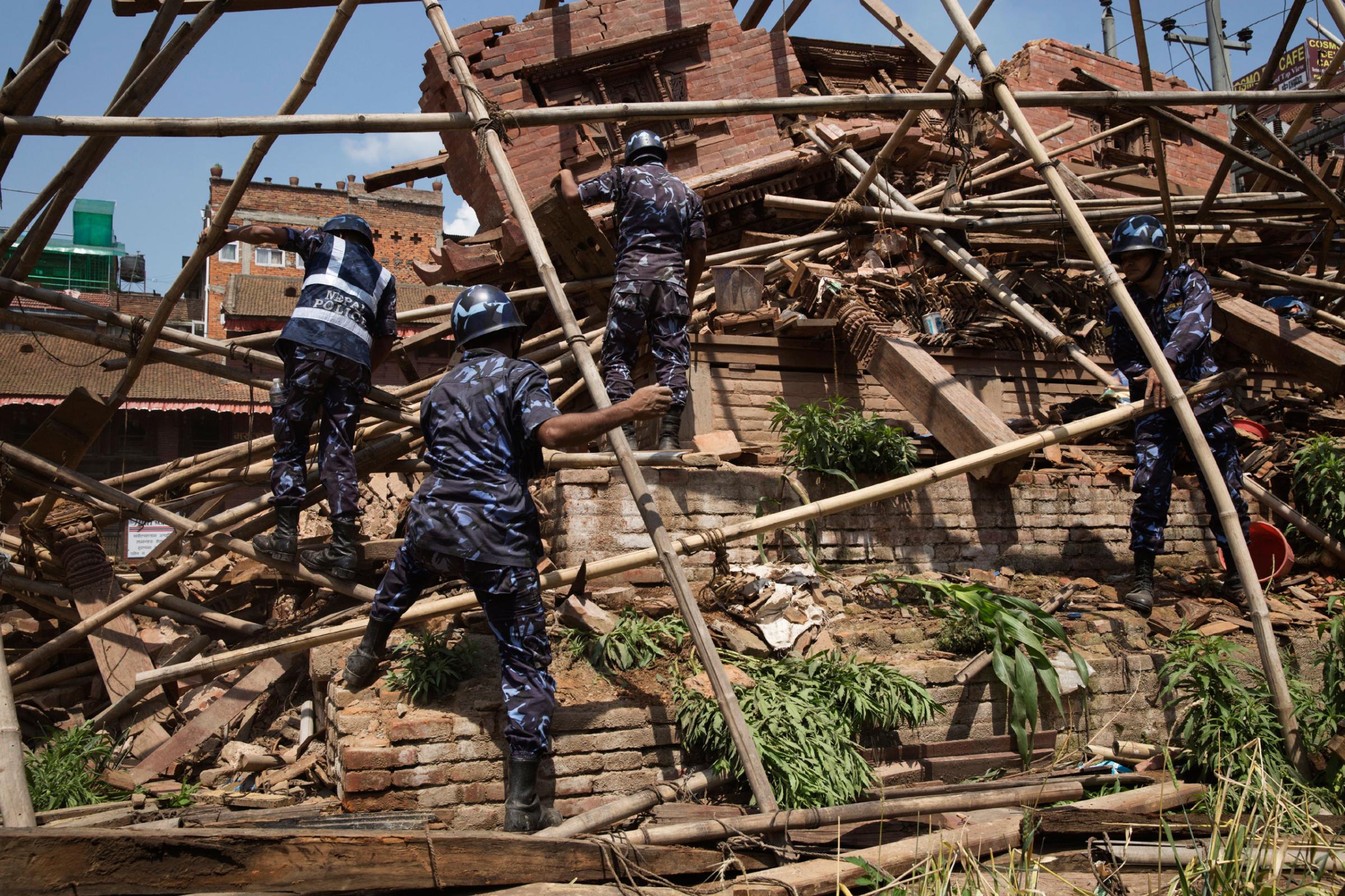 Nepali forces clear fallen bamboo from ruins in Durbar Square, Kathmandu, Nepal on April. 26, 2015. The historic Durbar Square, a UNESCO world heritage site, was severely damaged in an earthquake on April 25th. Photo by Adam Ferguson for Time