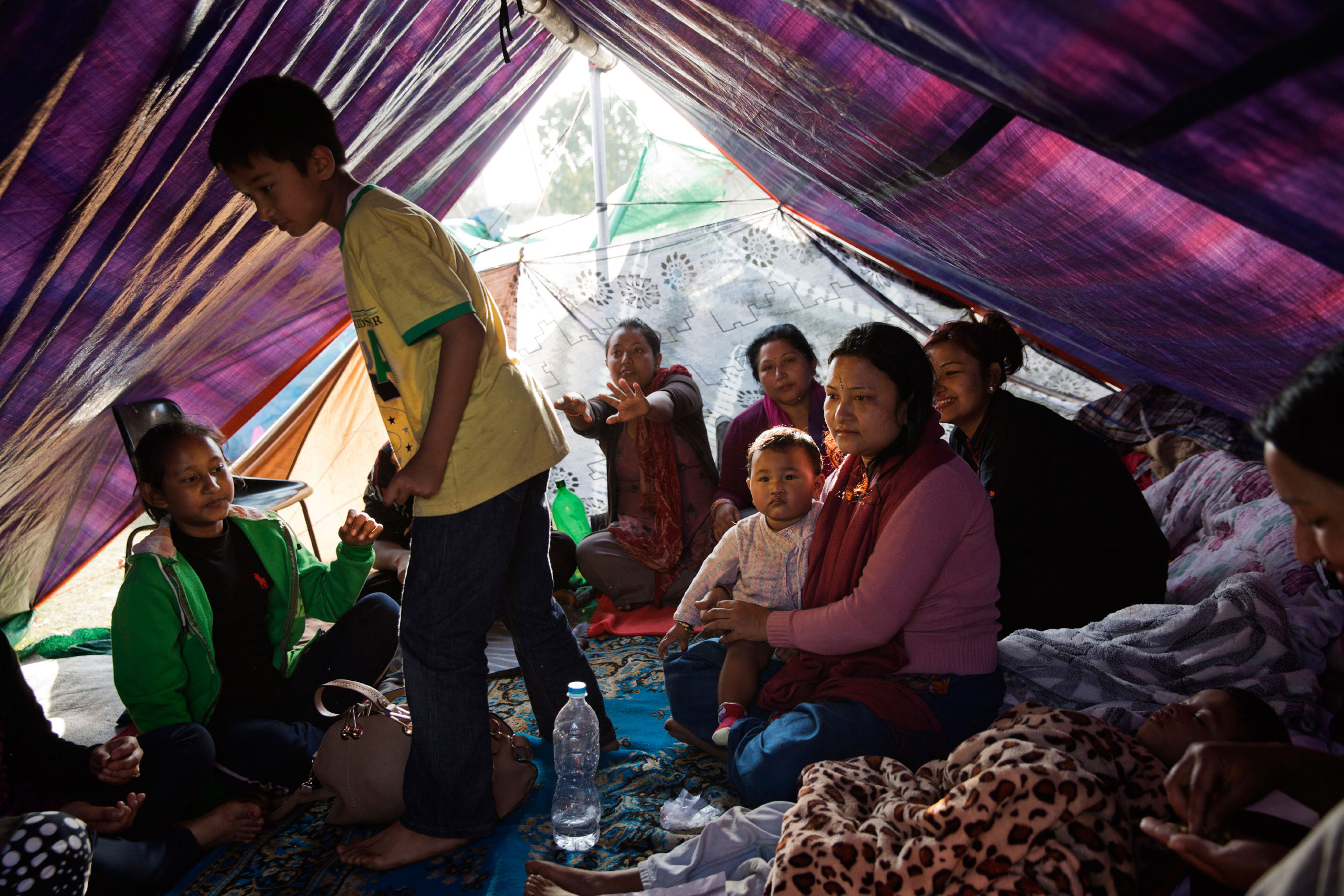 A displaced Nepalese family takes shelter in a tent in a Kathmandu park, April 27, 2015.