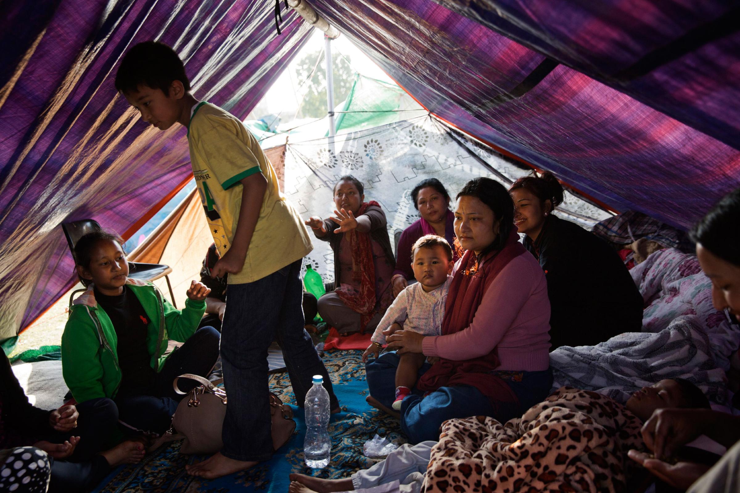 A displaced Nepali family take shelter in a tent in a park in Kathmandu, Nepal on April. 27, 2015. Nepal had a severe earthquake on April 25th. Photo by Adam Ferguson for Time