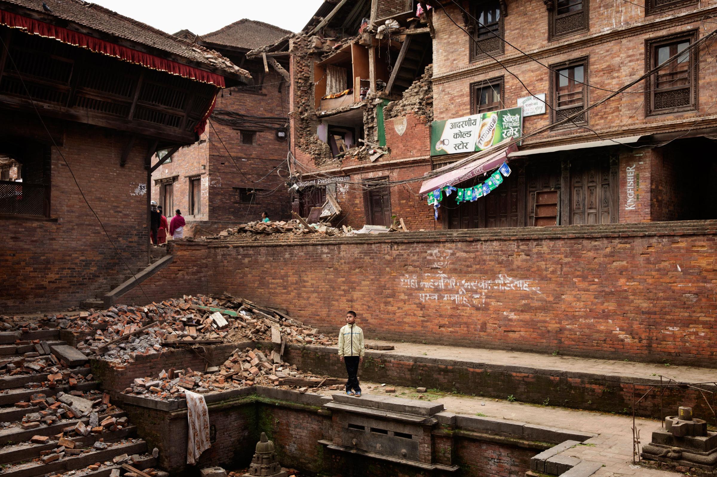 A Nepali boy stands amidst earthquake damage in the ancient city of Bhaktapur in the Kathmandu Valley on April. 28, 2015. Nepal had a severe earthquake on April 25th. Photo by Adam Ferguson for Time