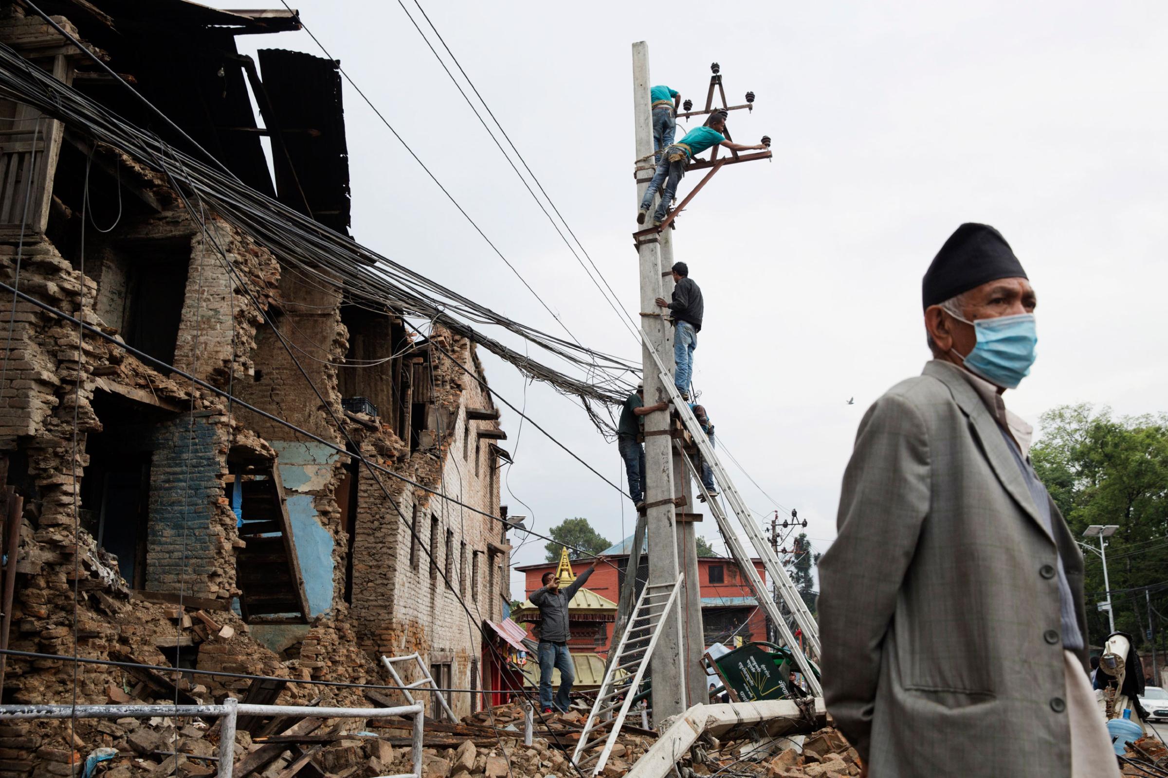 Workers repair power lines in Kathmandu, Nepal on April. 28, 2015. Nepal had a severe earthquake on April 25th. Photo by Adam Ferguson for Time
