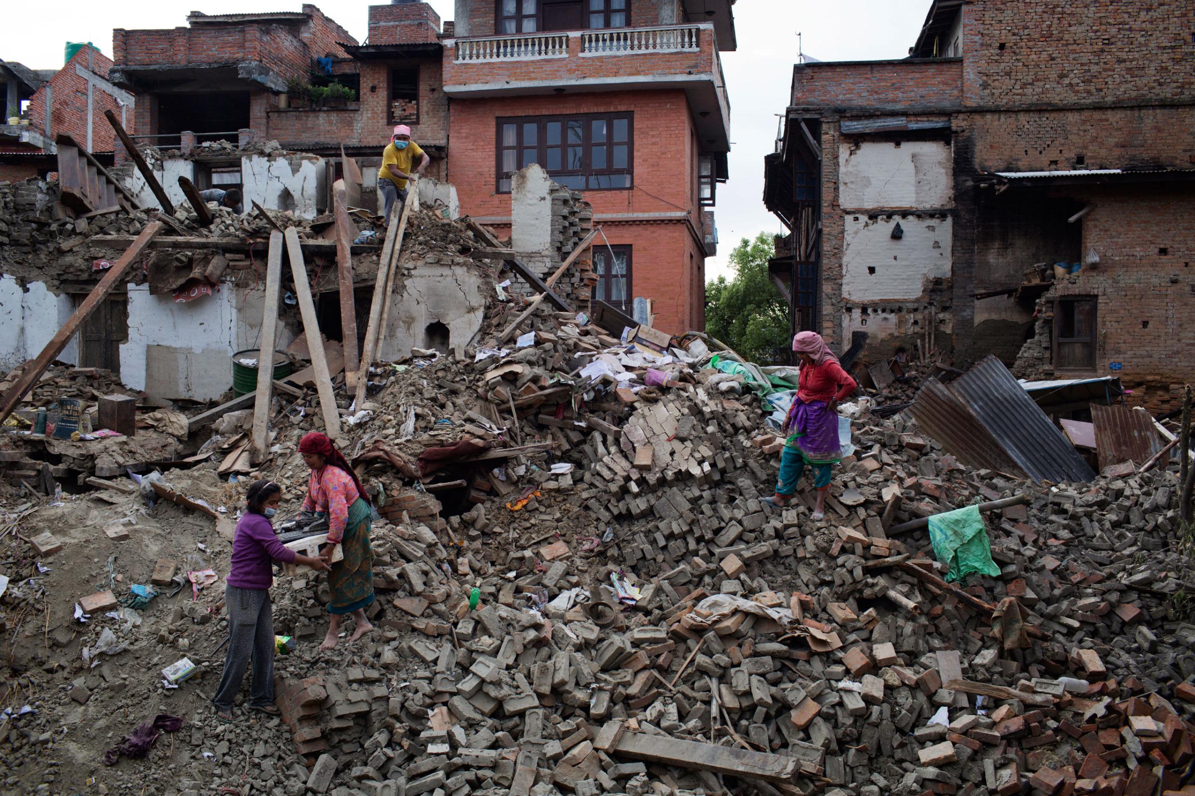 Nepalis retrieve belongings from earthquake damaged homes in the ancient city of Bhaktapur in the Kathmandu Valley on April 29, 2015. Nepal had a severe earthquake on April 25th. Photo by Adam Ferguson for Time