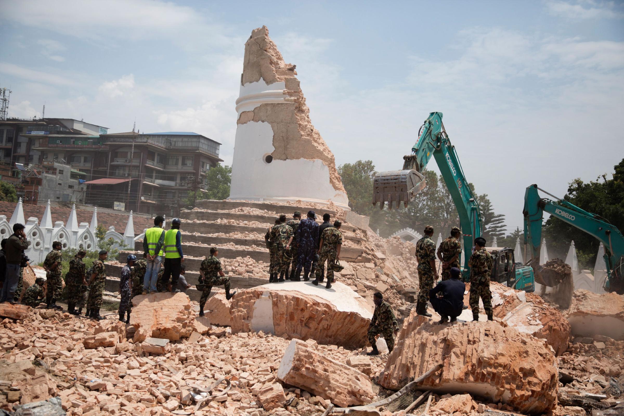 Nepali forces excavate the Dharahara tower in Kathmandu, Nepal on April. 26, 2015. This as well as historic Durbar Square, both UNESCO world heritage sites, were severely damaged in an earthquake on April 25th. Photo by Adam Ferguson for Time