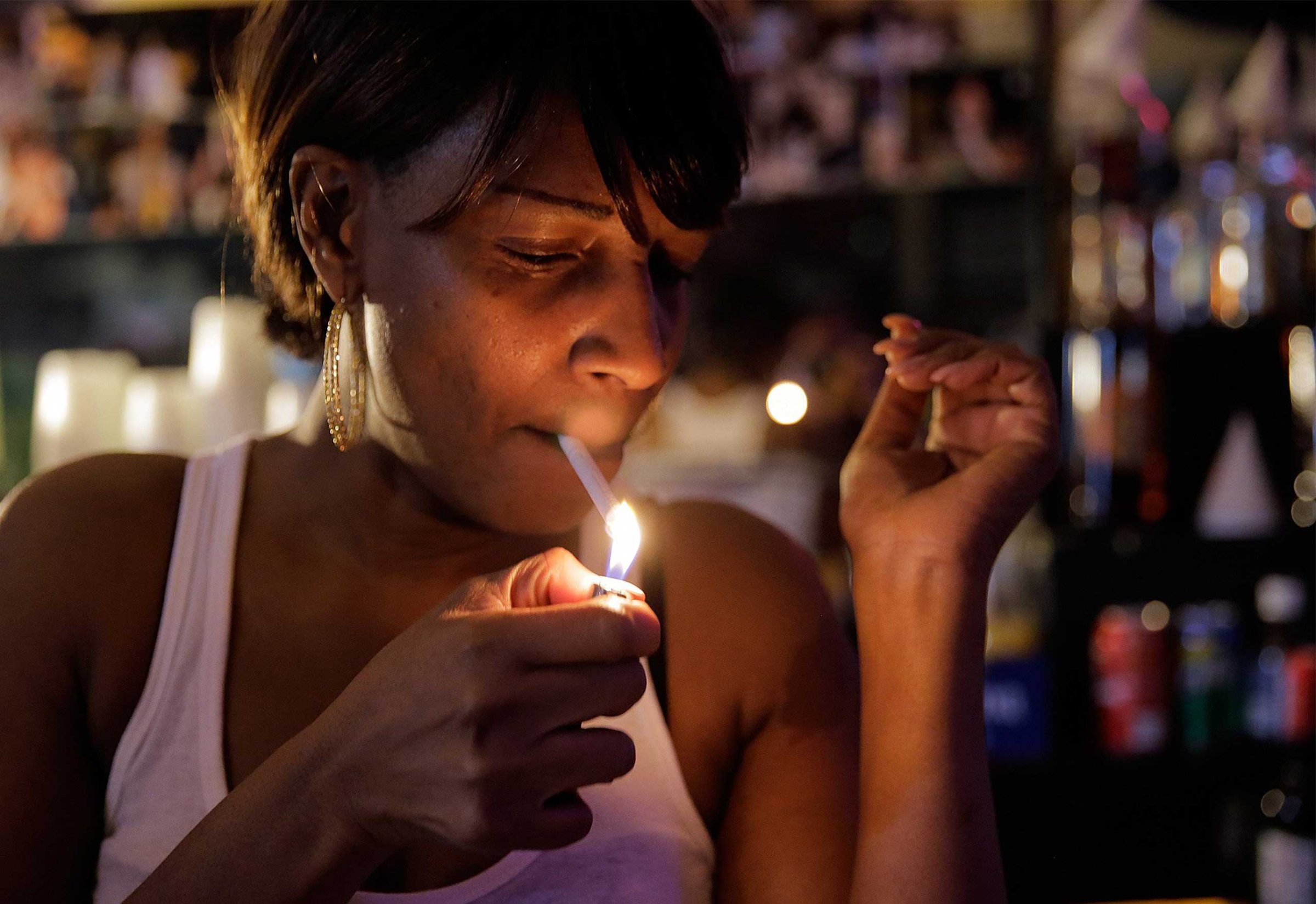 Judy Hill, owner of the Ooh Poo Pah Doo Bar in New Orleans, enjoys a smoke just days before the new city smoking ordinance on April 17, 2015.
