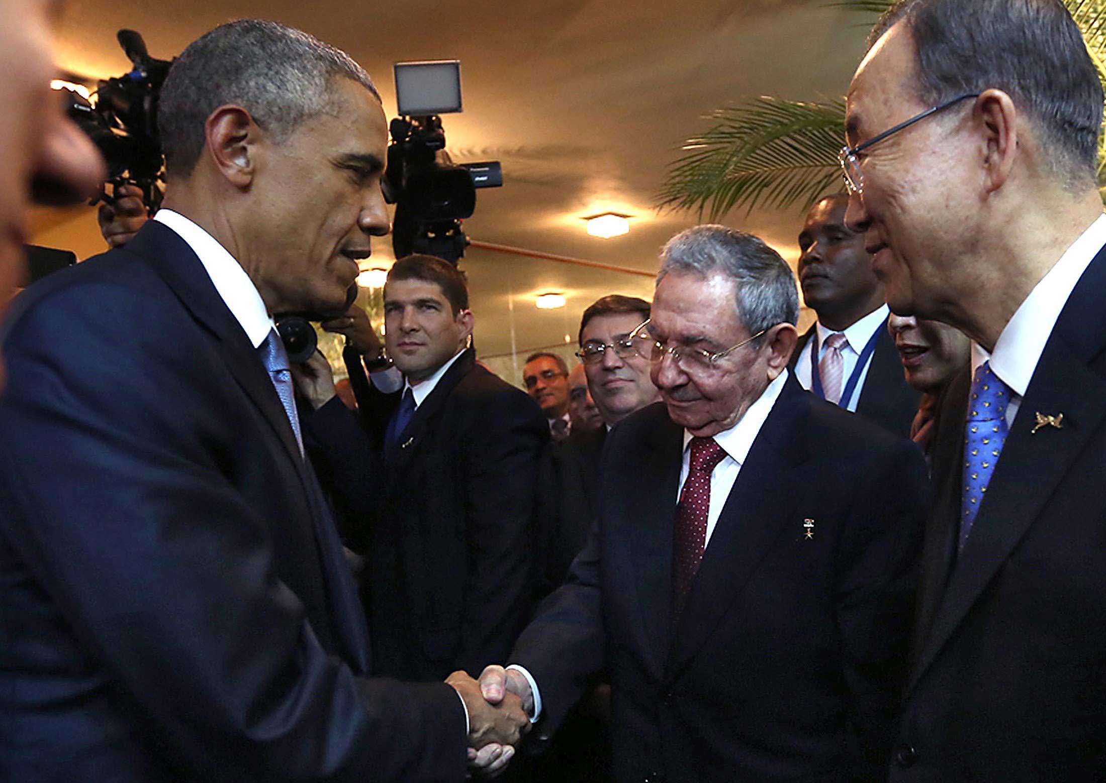 Cuban President Raul Castro (2-R) and US President Barack Obama (L) shaking hands as Castro's grandson and bodyguard Raul Rodriguez Castro (2-L), Cuban Foreign Minister Bruno Rodriguez (C) and United Nations chief Ban Ki-moon (R) look on, moments before the opening ceremony of the VII Americas Summit, in Panama City on April 10, 2015.