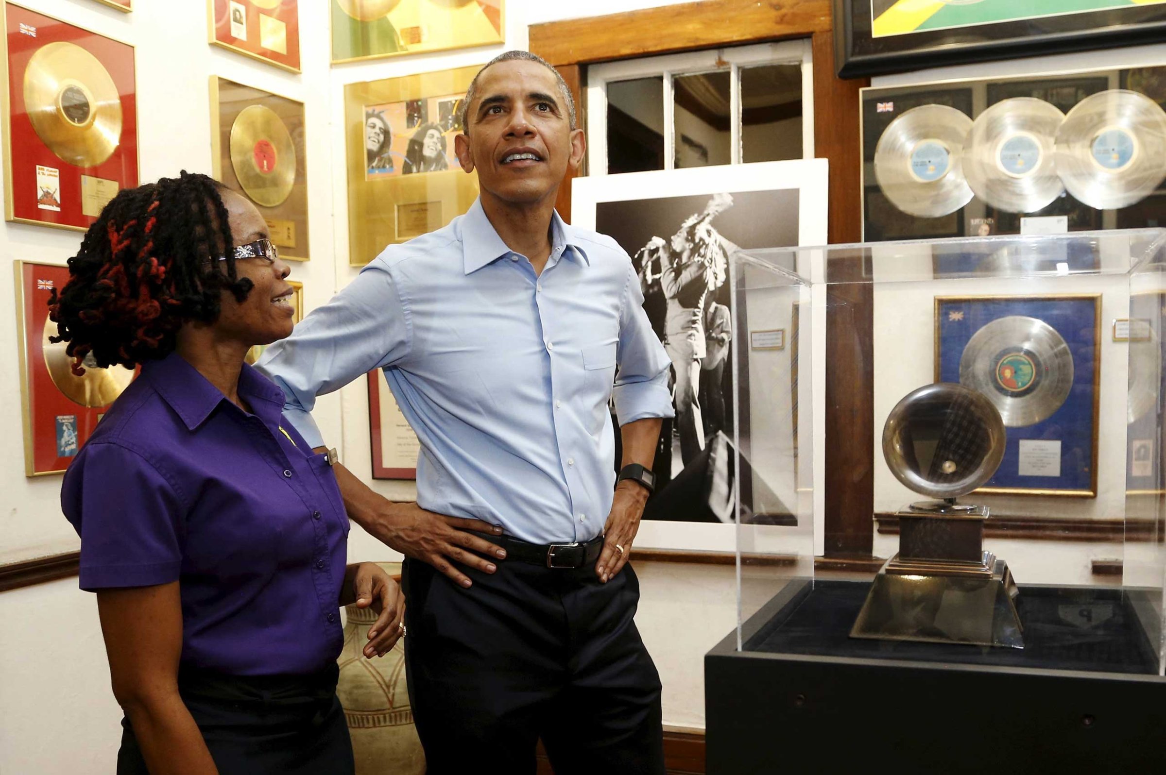 U.S. President Barack Obama gets a tour of the Bob Marley Museum from staff member Natasha Clark (L) in Kingston, Jamaica on April 8, 2015.