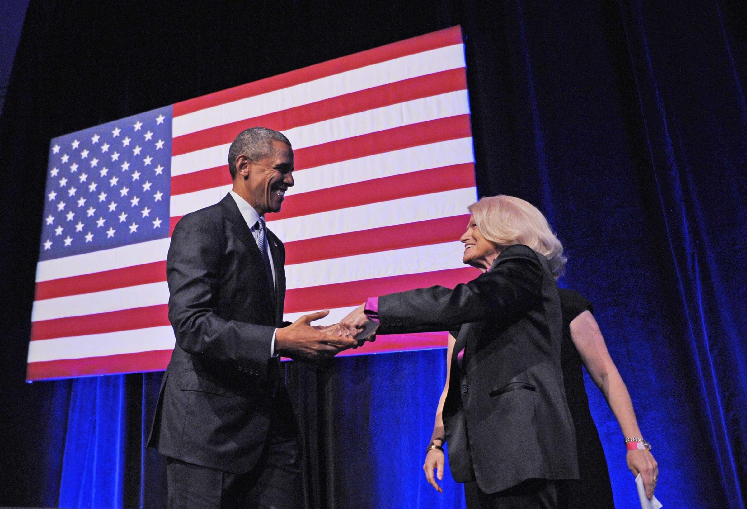 President Barack Obama holds hands with Edie Windsor after she introduced him during the Democratic National Committee LGBT Gala at Gotham Hall in New York City on June 17, 2014.