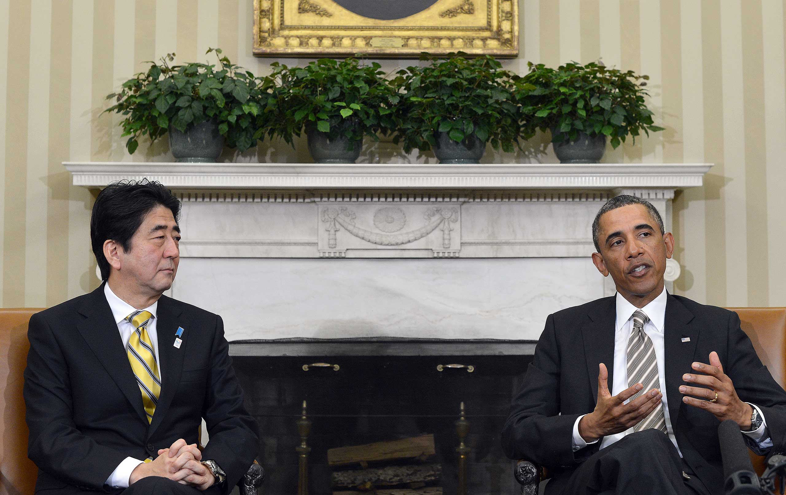 US President Barack Obama speaks while Japan's new conservative Prime Minister Shinzo Abe listens, following their bilateral meeting in the Oval Office at the White House in Washington, DC, on Feb. 22, 2013. (Jewel Samad—AFP/Getty Images)
