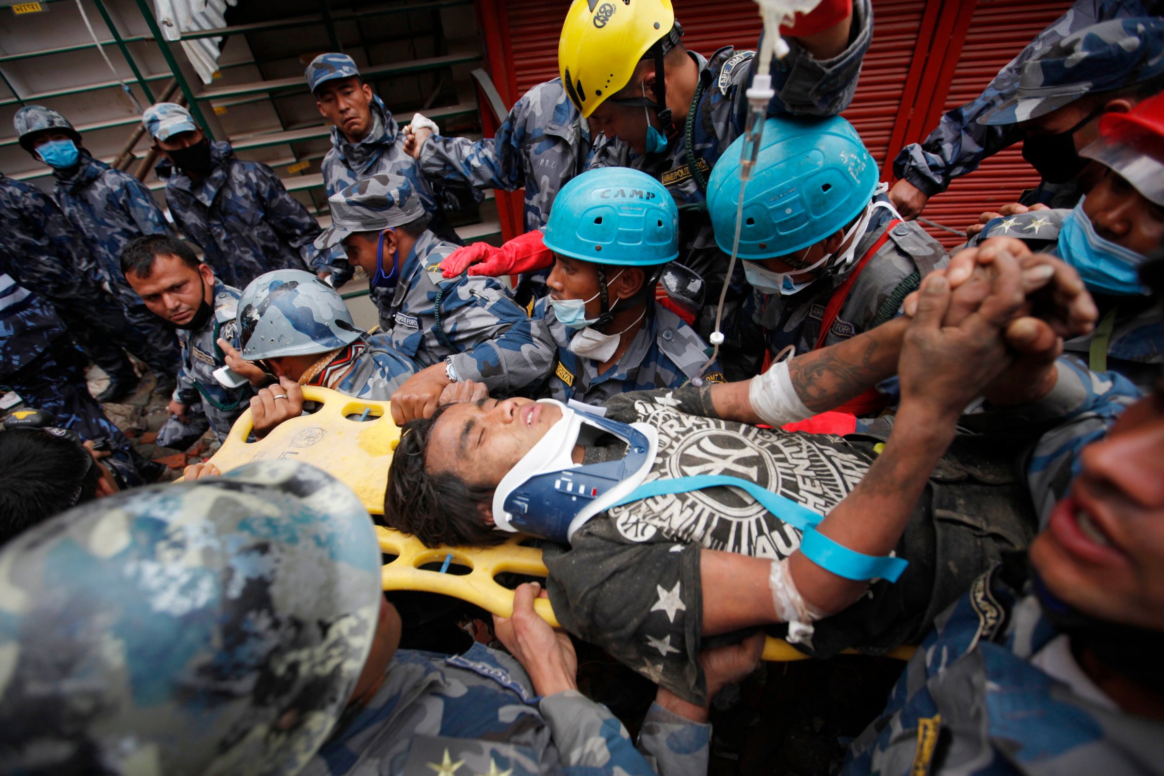 Pemba Tamang is carried on a stretcher after being rescued by Nepalese policemen and U.S. rescue workers from a building that collapsed five days ago in Kathmandu, Nepal on April 30, 2015.