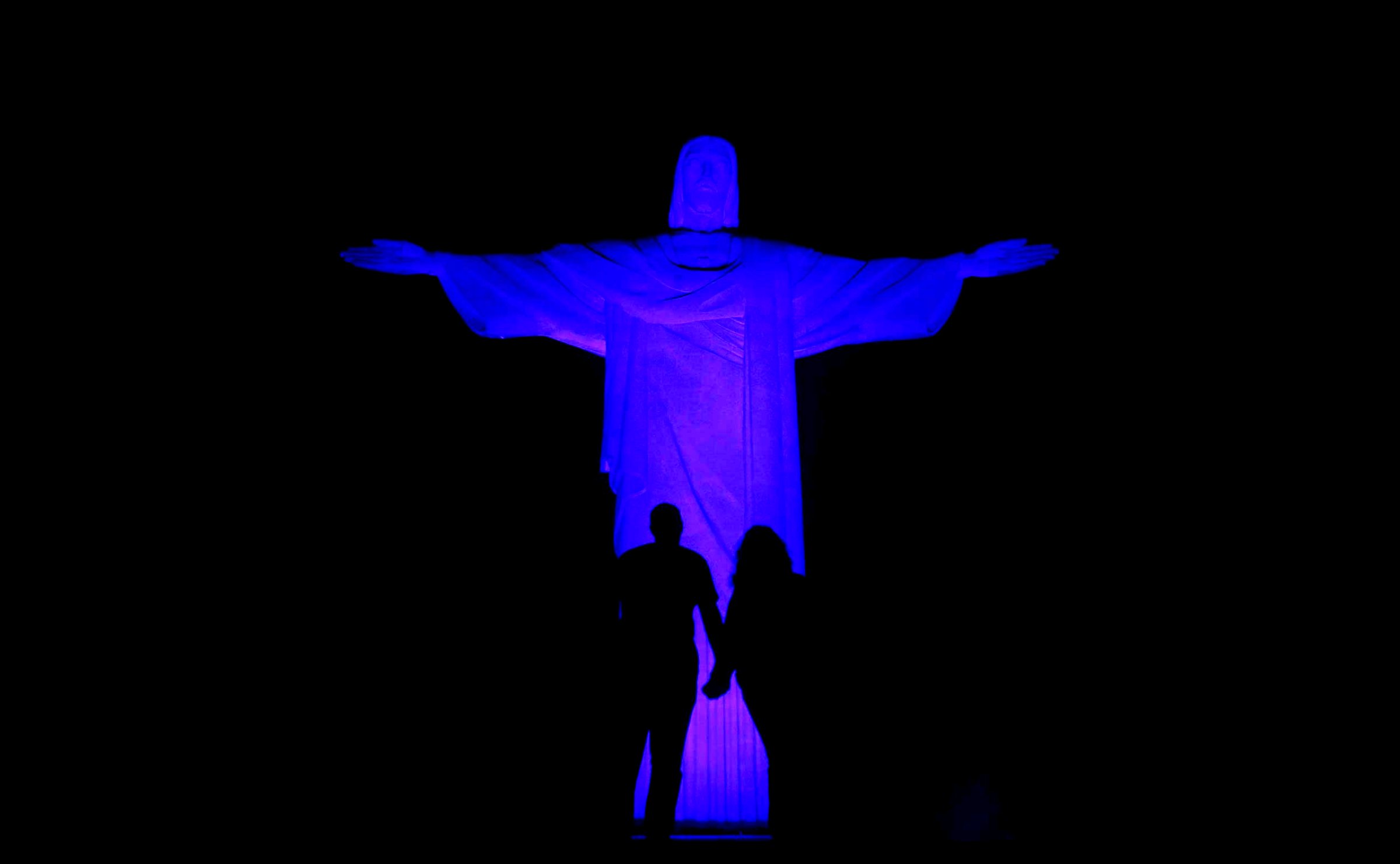The statue of Christ the Redeemer is lit up in blue for the "Light It Up Blue" campaign to mark the World Autism Awareness Day in Rio de Janeiro