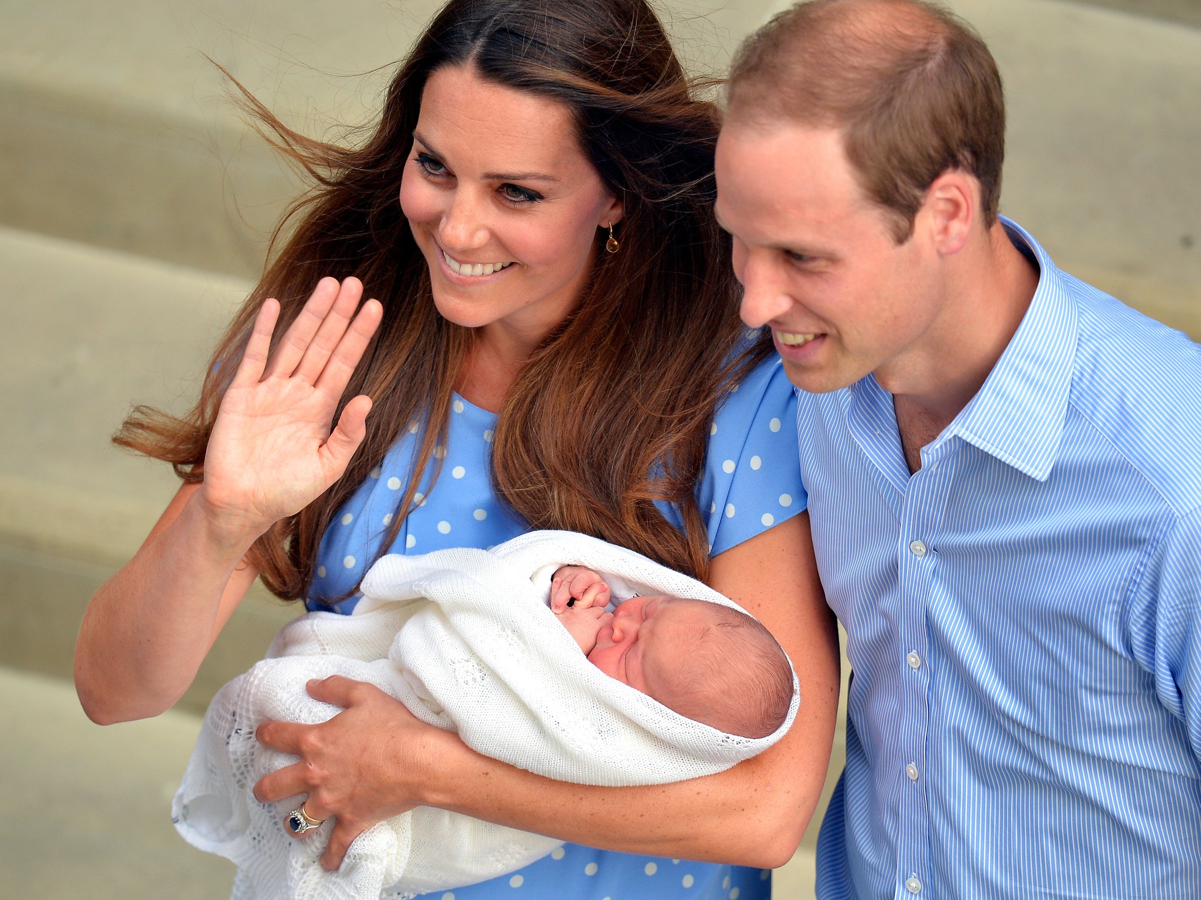 Prince William and Catherine, Duchess of Cambridge show their new-born baby boy to the world's media outside the Lindo Wing of St Mary's Hospital in London on July 23, 2013. The baby was born on Monday afternoon weighing eight pounds six ounces (3.8 kilogrammes). The baby, titled His Royal Highness, Prince (name) of Cambridge, is directly in line to inherit the throne after Charles, Queen Elizabeth II's eldest son and heir, and his eldest son William. AFP PHOTO / POOL / John Stillwell (Photo credit should read JOHN STILLWELL/AFP/Getty Images)