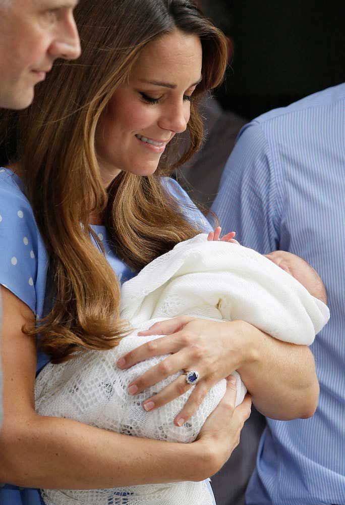 Kate, Duchess of Cambridge holds the Prince of Cambridge, Tuesday July 23, 2013, as they pose for photographers outside St. Mary's Hospital exclusive Lindo Wing in London where the Duchess gave birth on Monday July 22. The Royal couple are expected to head to Londonís Kensington Palace from the hospital with their newly born son, the third in line to the British throne. (AP Photo/Alastair Grant)