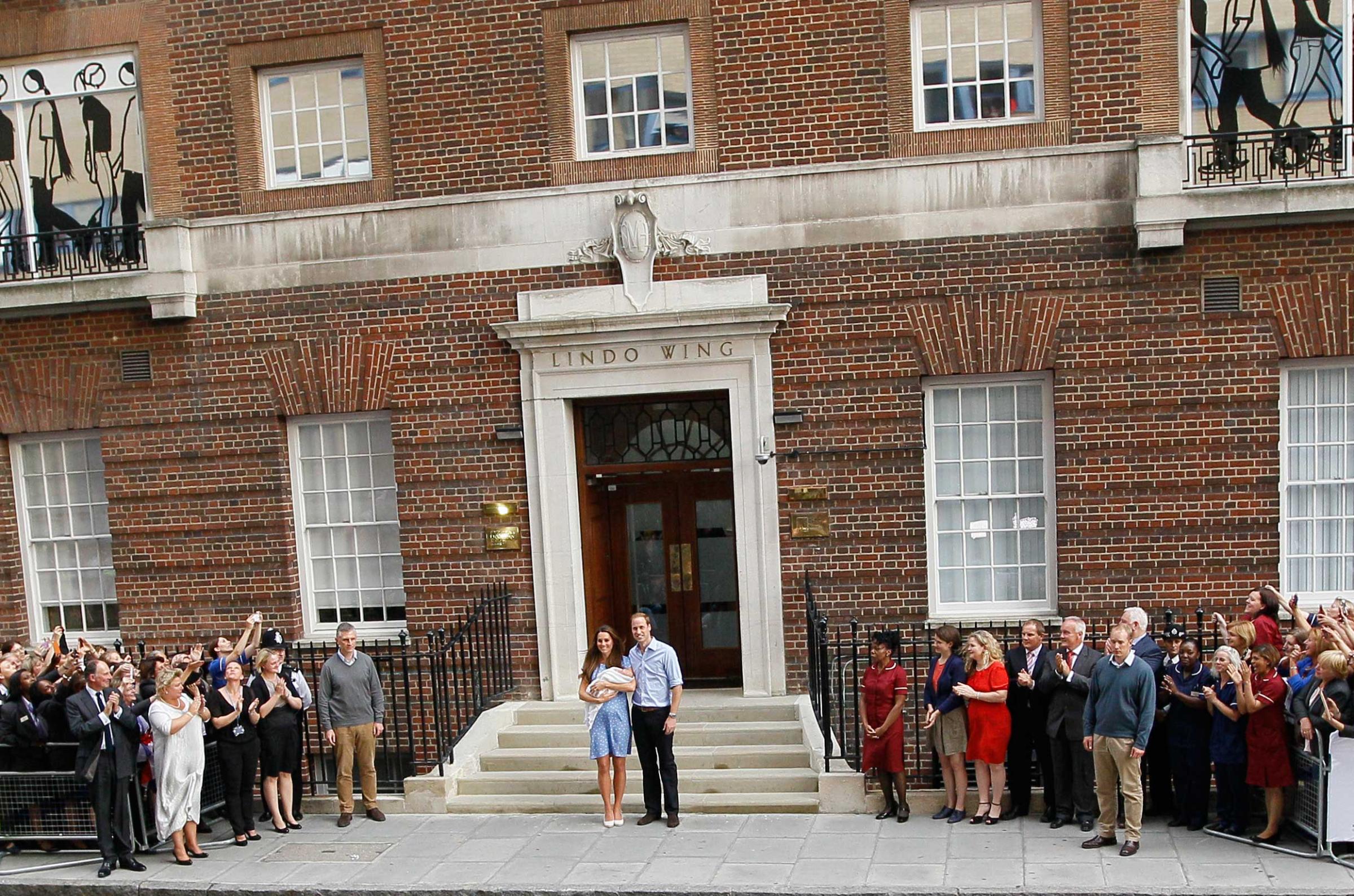 Britain's Prince William, right, and Kate, Duchess of Cambridge hold the Prince of Cambridge, Tuesday July 23, 2013, as they pose for photographers outside St. Mary's Hospital exclusive Lindo Wing in London where the Duchess gave birth on Monday July 22. The boy, who is third in line to the British throne, has since been named George Alexander Louis by his parents and will be known as Prince George of Cambridge. (AP Photo/Kirsty Wigglesworth)