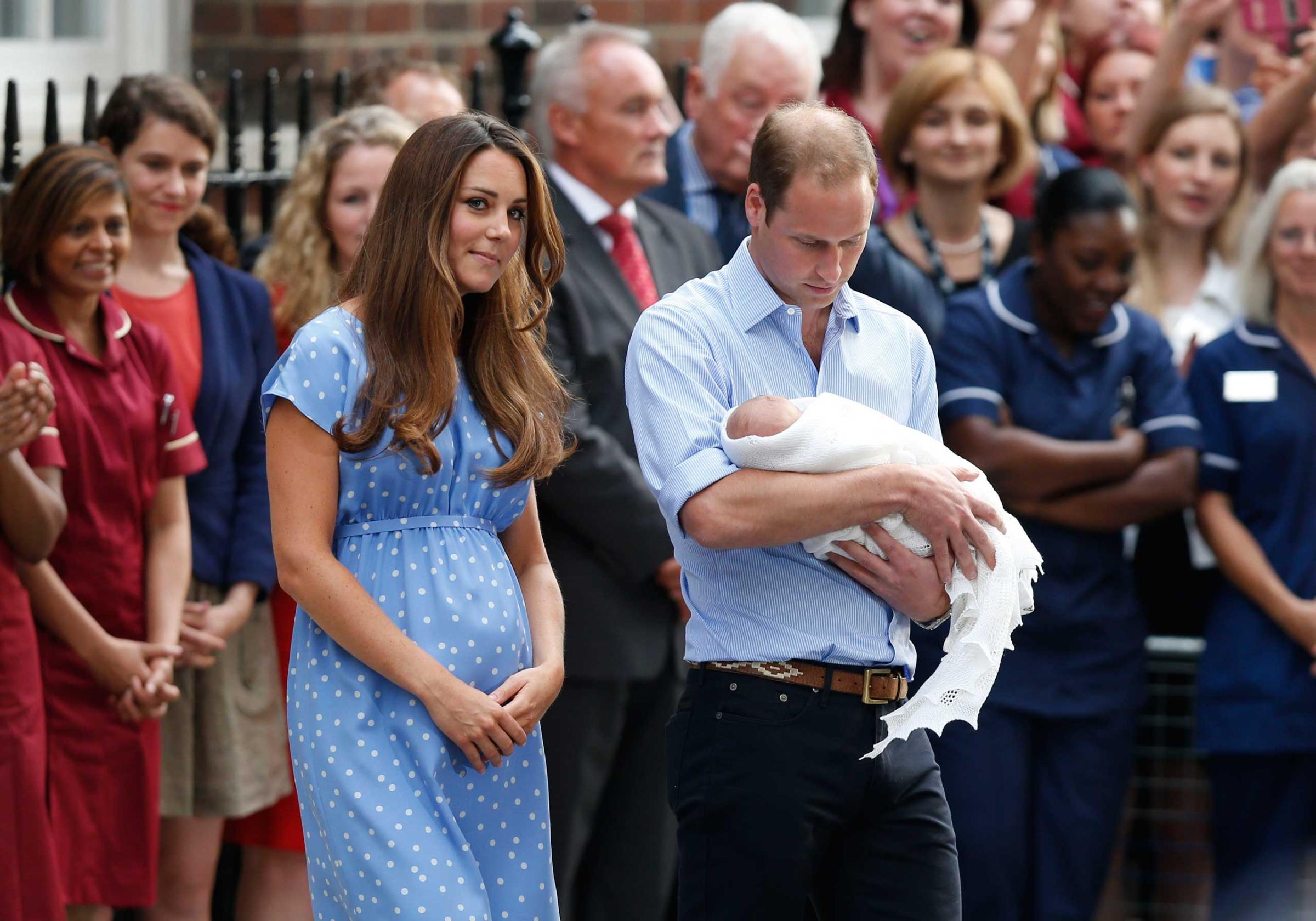 Britain's Prince William, right, and Kate, Duchess of Cambridge hold the Prince of Cambridge, Tuesday July 23, 2013, as they pose for photographers outside St. Mary's Hospital exclusive Lindo Wing in London where the Duchess gave birth on Monday July 22. The boy, who is third in line to the British throne, has since been named George Alexander Louis by his parents and will be known as Prince George of Cambridge. (AP Photo/Sang Tan)