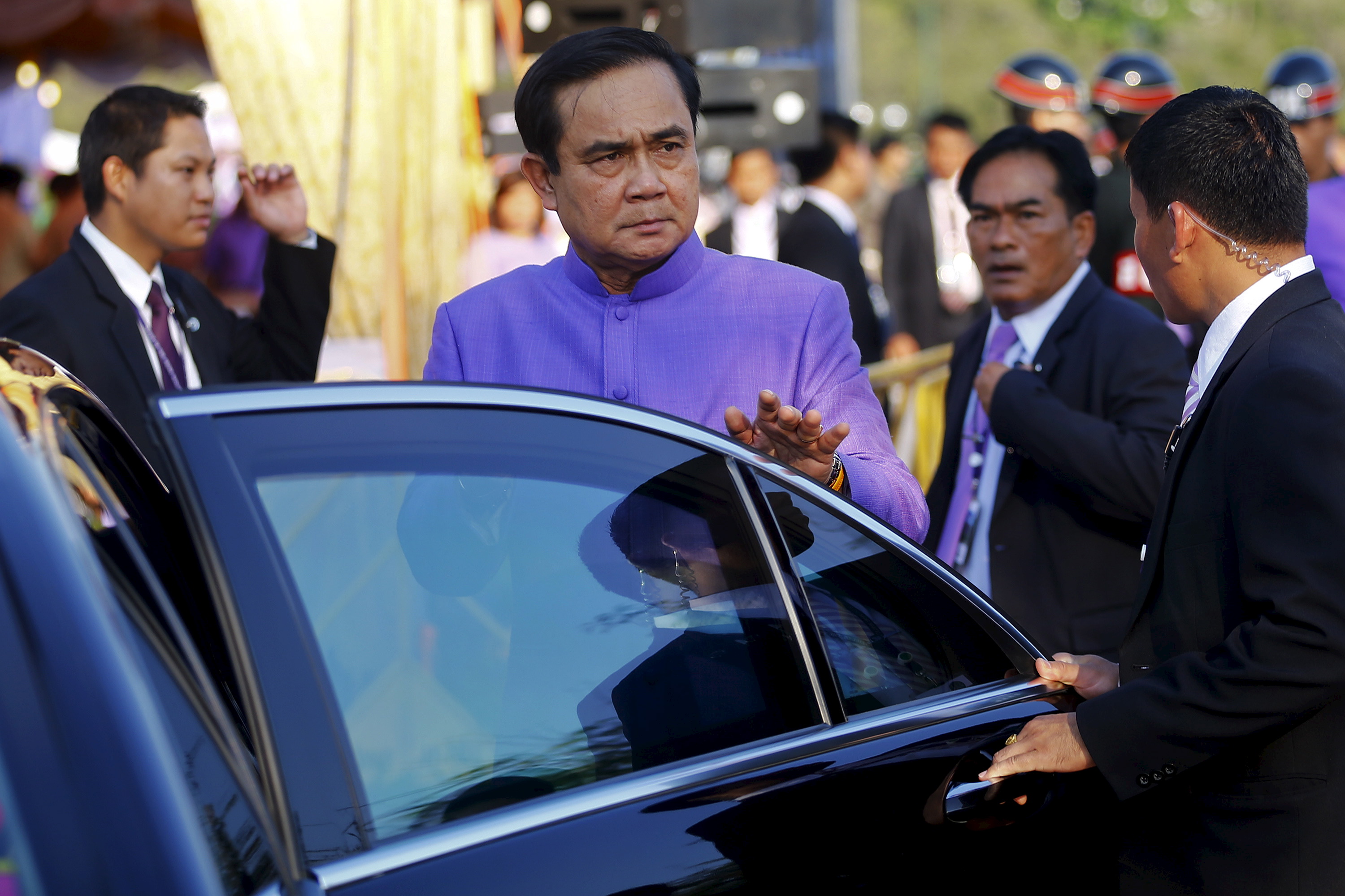 Prime Minister Prayuth Chan-ocha gets in his car after the merit-making ceremony on the occasion of Princess Maha Chakri Sirindhorn's birthday at Sanam Luang in Bangkok