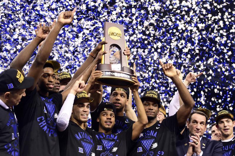 Duke Blue Devils guard Quinn Cook and teammates hoist the NCAA championship trophy after defeating the Wisconsin Badgers at Lucas Oil Stadium in Indianapolis on April 6, 2015 (Bob Donnan—USA TODAY Sports/Reuters)