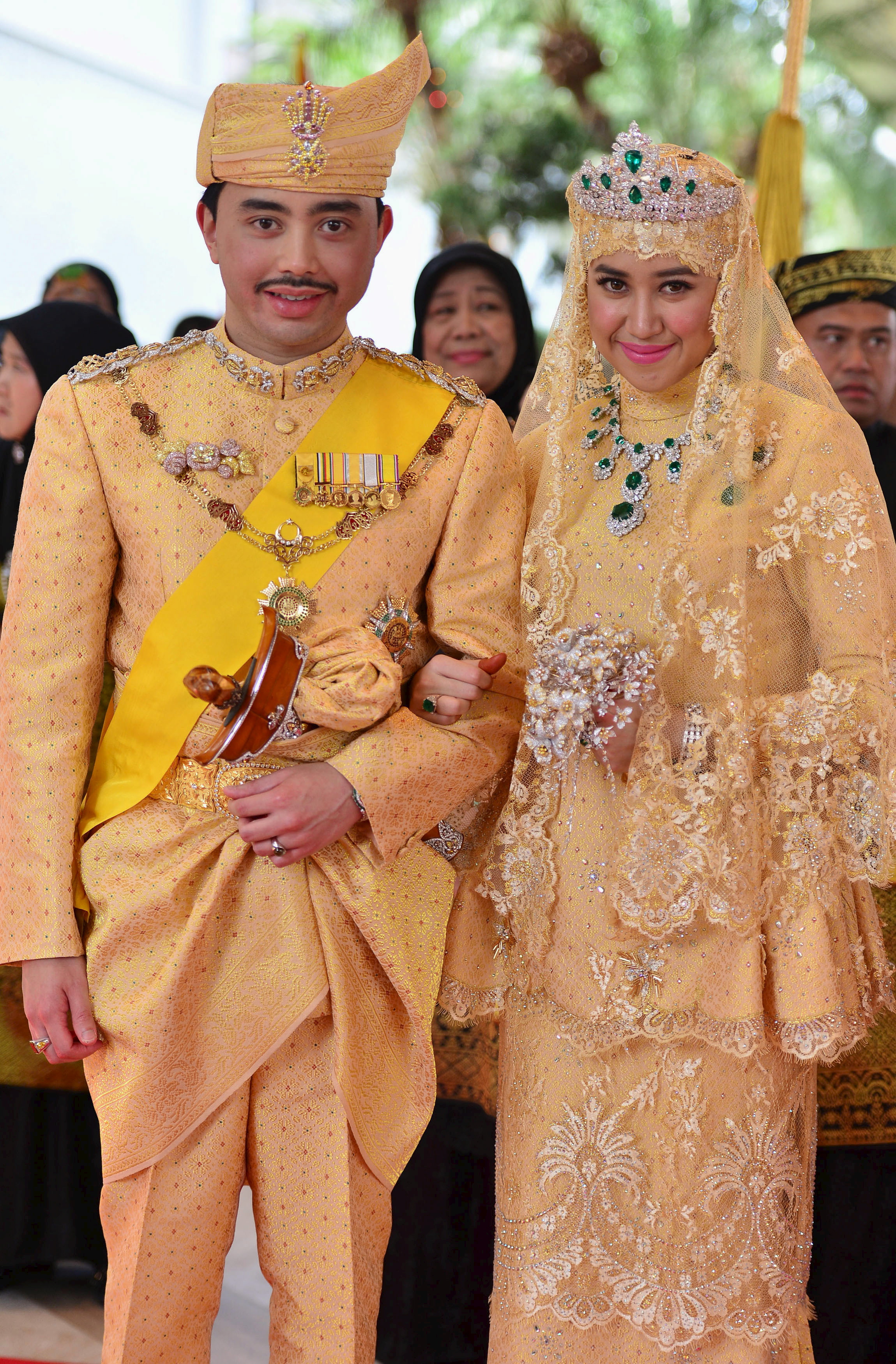 Brunei's newly wed royal couple, Prince Abdul Malik and Dayangku Raabi'atul 'Adawiyyah Pengiran Haji Bolkiah, pose for photographers after the 