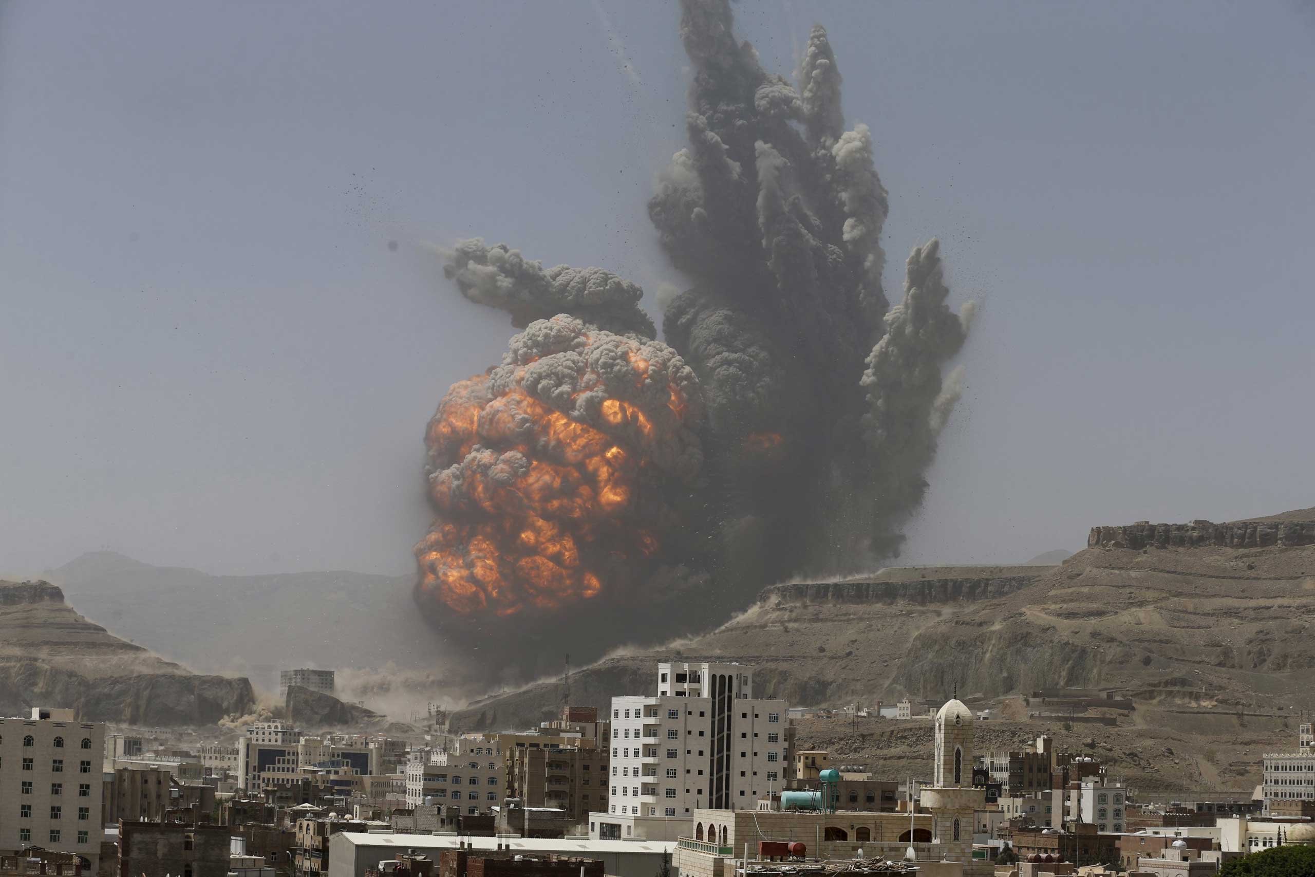 Smoke rises during an air strike on an army weapons depot on a mountain overlooking Yemen's capital Sanaa April 20, 2015.