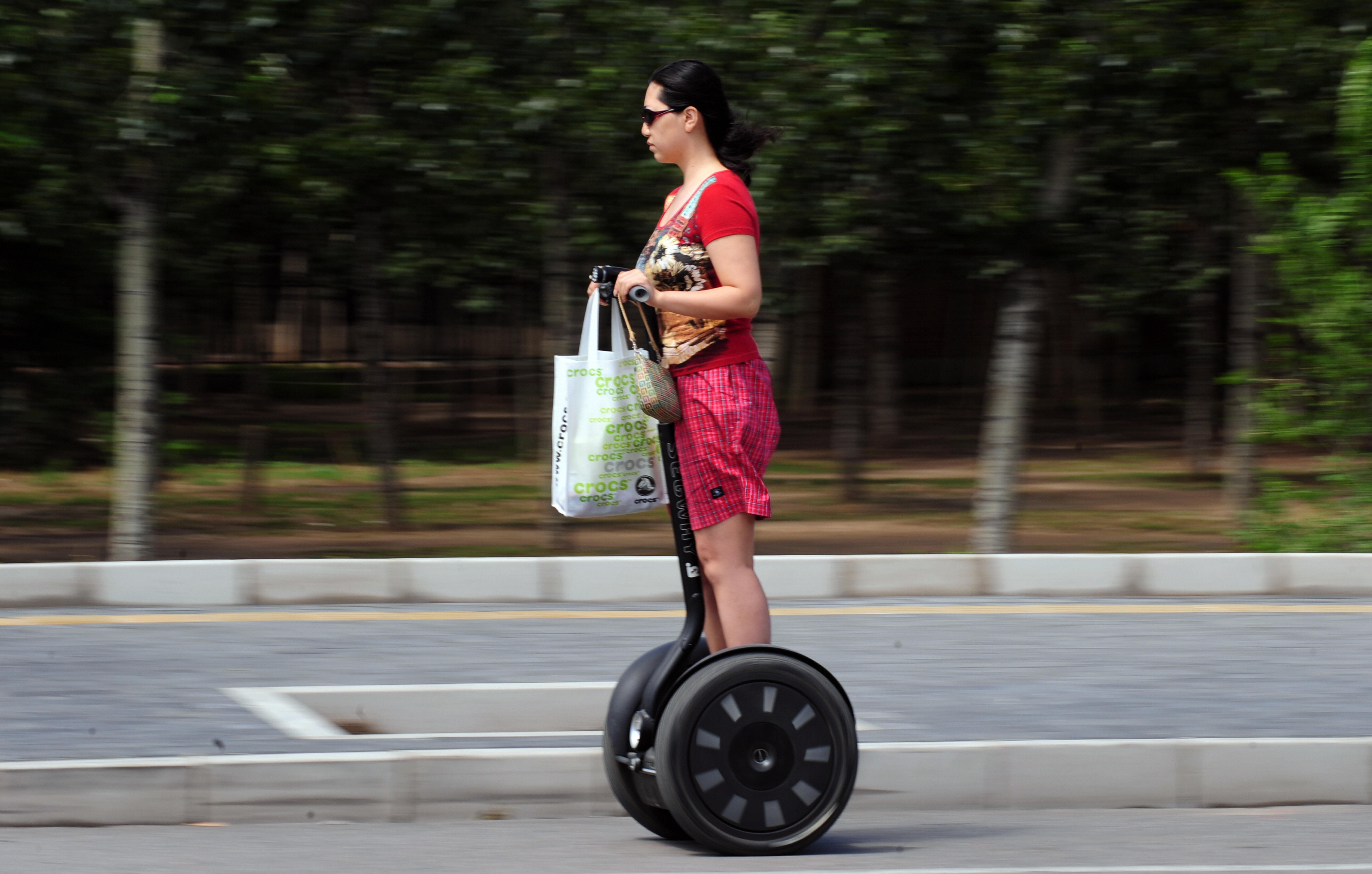 A woman commutes on a Segway electric, self-balancing scooter in Beijing, China, on June 9, 2009. (Frederic J. Brown—AFP/Getty Images)