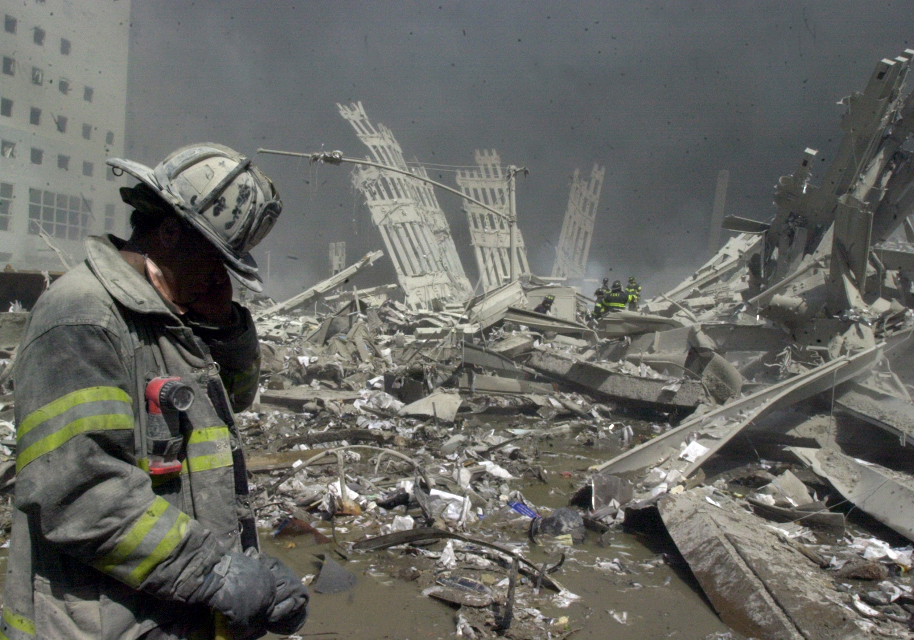 Firefighter walks through the rubble of the World Trade Center after it was struck by commercial airliners in a terrorist attack, Sept. 12 2001. after the first. (Todd Maisel—New York Daily News/Getty Images)