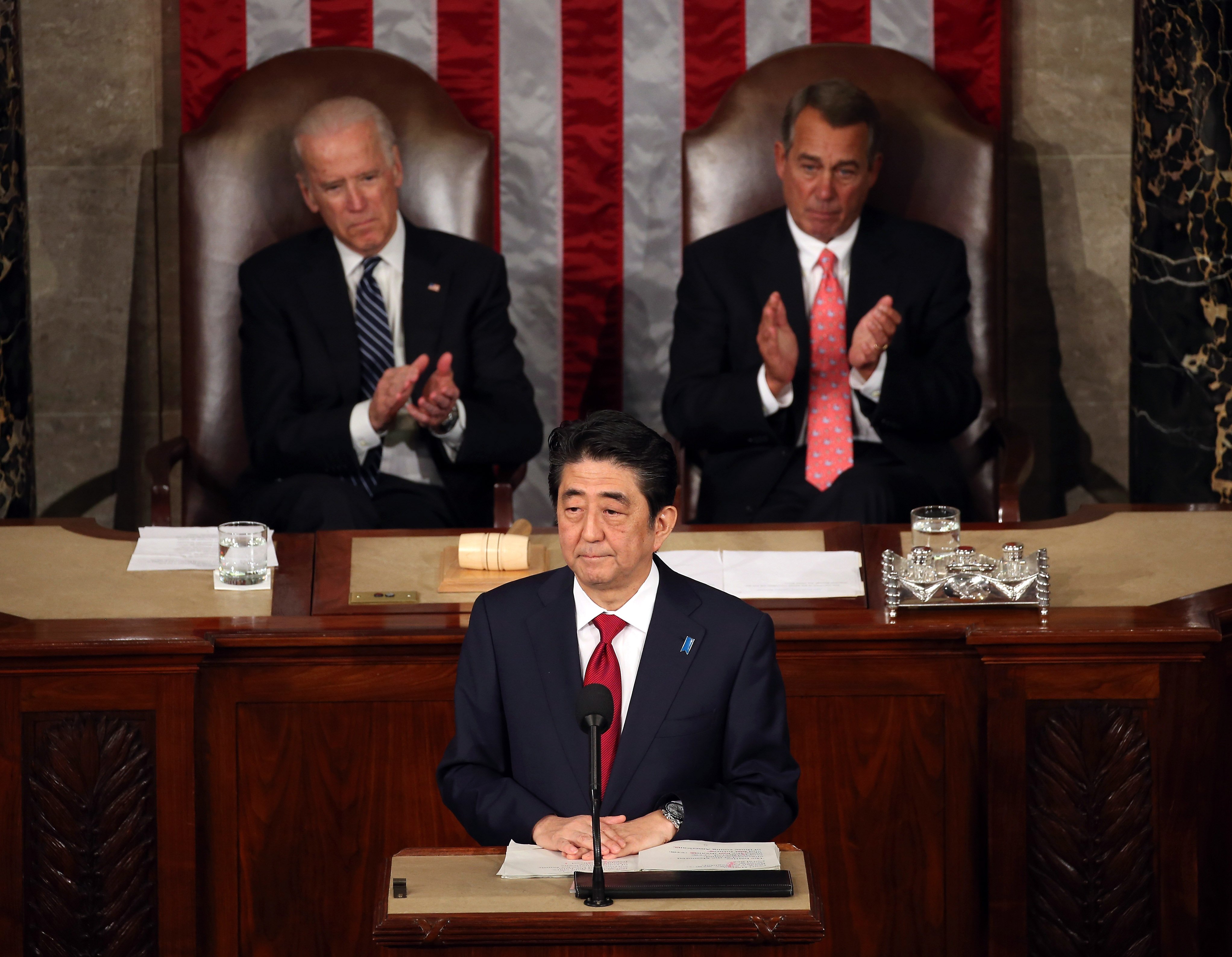 Japanese Prime Minister Shinzo Abe speaks to a joint meeting of the US Congress while flanked by Vice President Joseph Biden (L) and House Speaker John Boehner (R-OH) (R) in the House chamber of the US Capitol on April 29, 2015 in Washington.