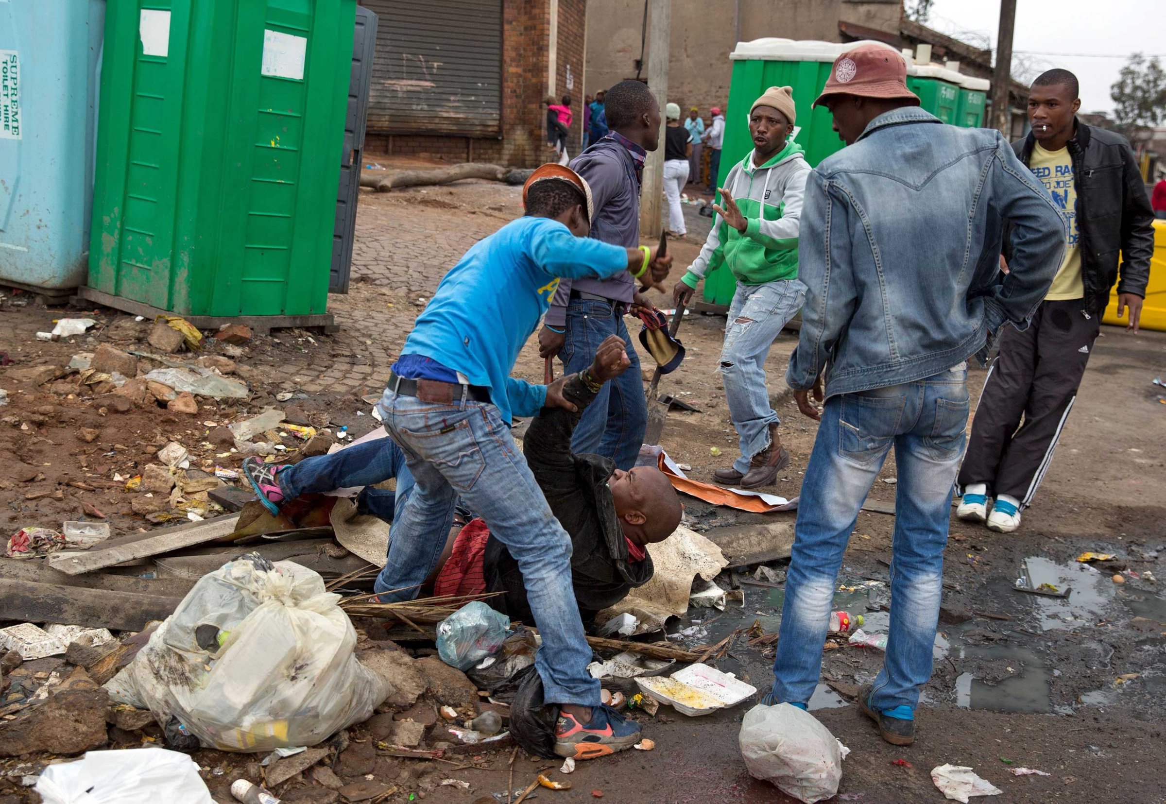Mozambique national Emmanuel Sithole is attacked by men in Alexandra township during anti-immigrant violence in Johannesburg on April 18, 2015.