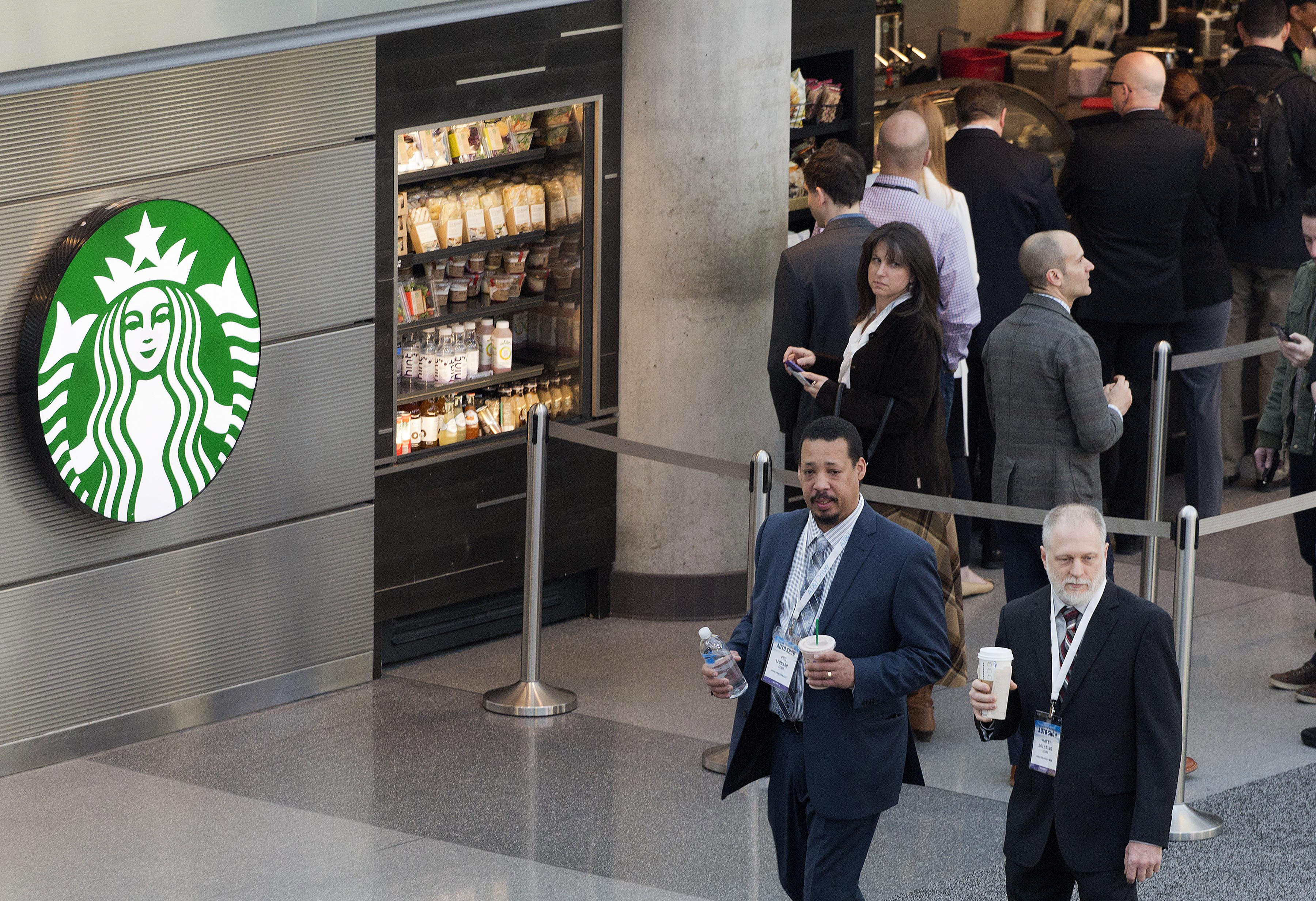 Customers line up at a Starbucks, April 2, 2015 in New York. (Mark Lennihan—AP)