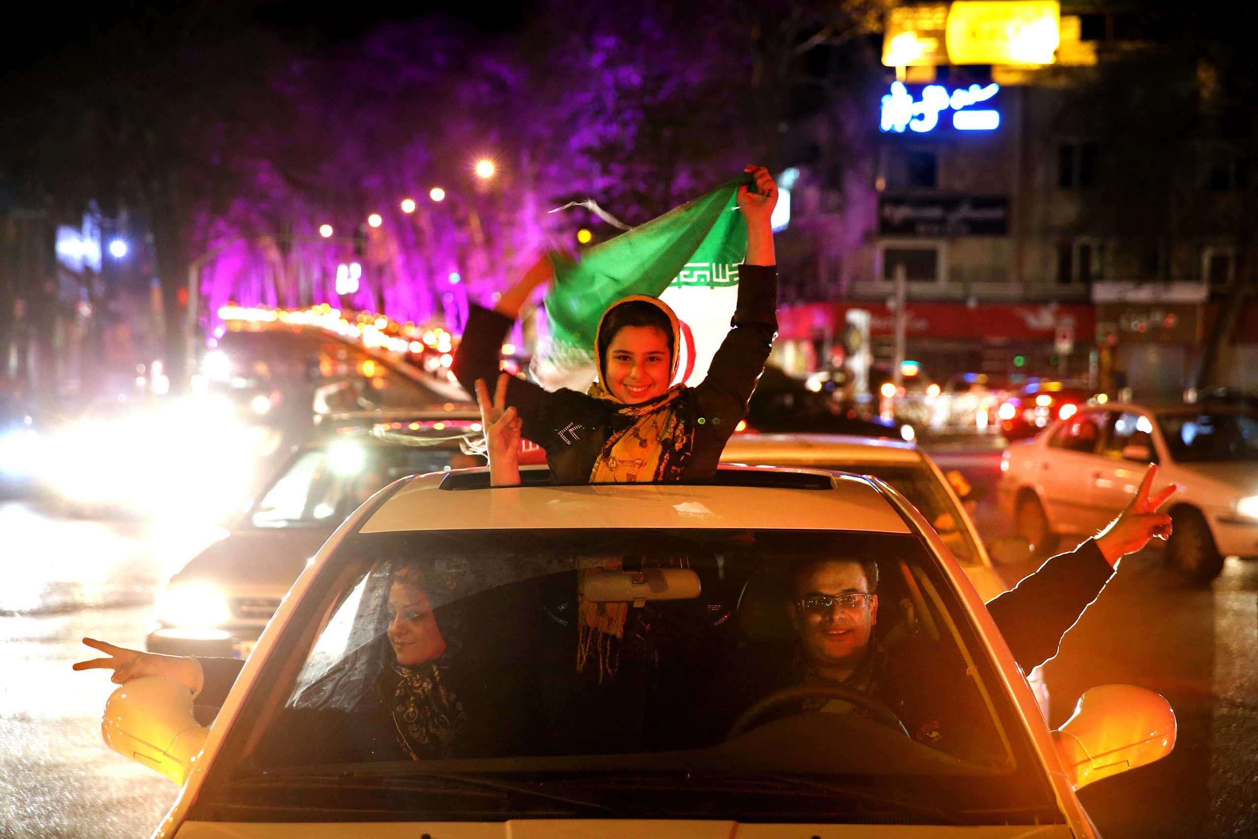 Iranians celebrate Iran's nuclear agreement with world powers on a street in northern Tehran, Iran, on Apr. 2, 2015. (Ebrahim Noroozi—AP)