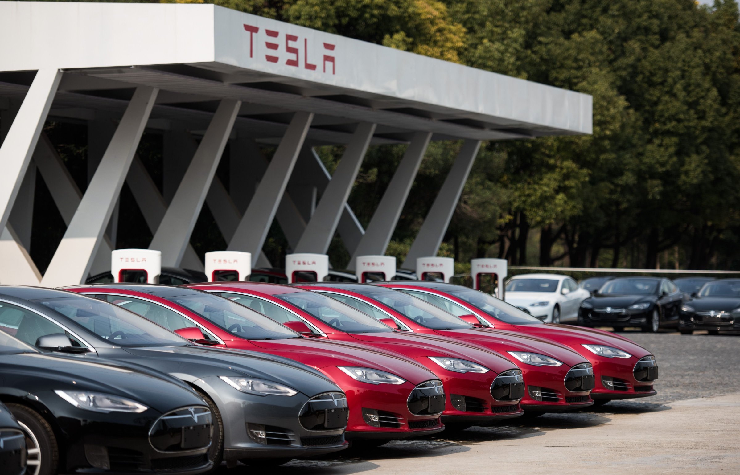 Tesla Model S vehicles parked outside a car dealership in Shanghai on March 17, 2015.