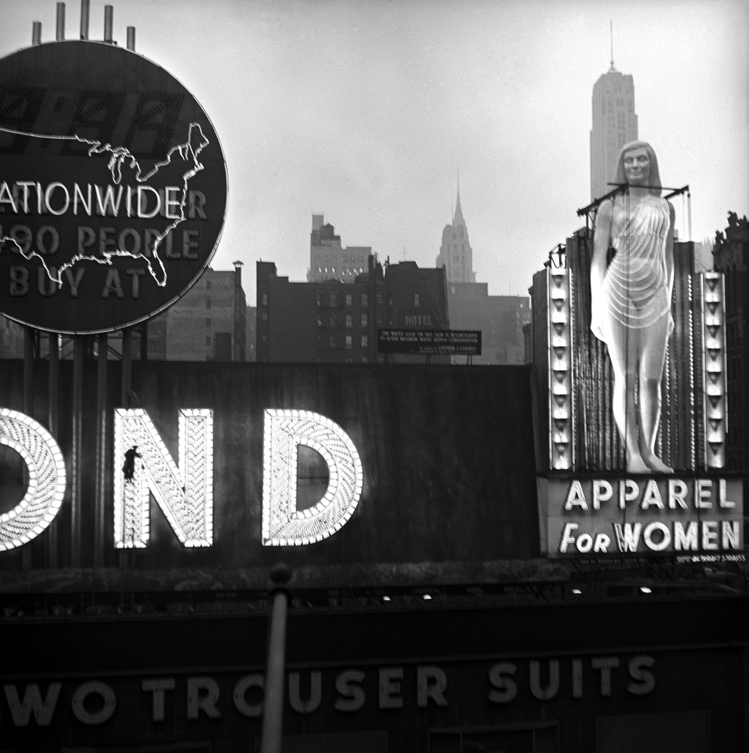 USA. New York City. Times Square. Clothing shop advertisment. 1950