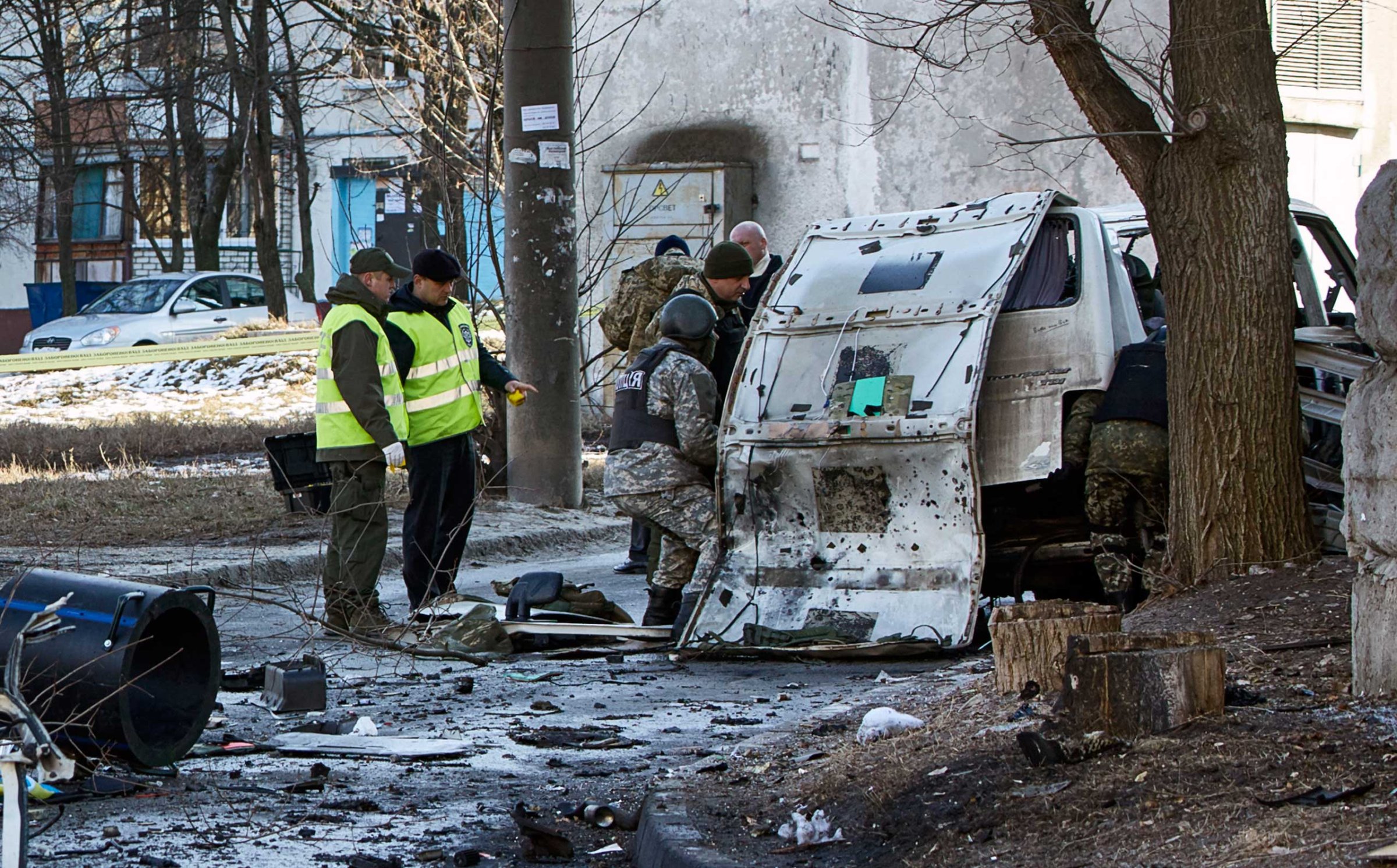 Ukrainian police and forensic experts examine the wreckage of a mini-bus after explosion, in Kharkov, March 6, 2015.