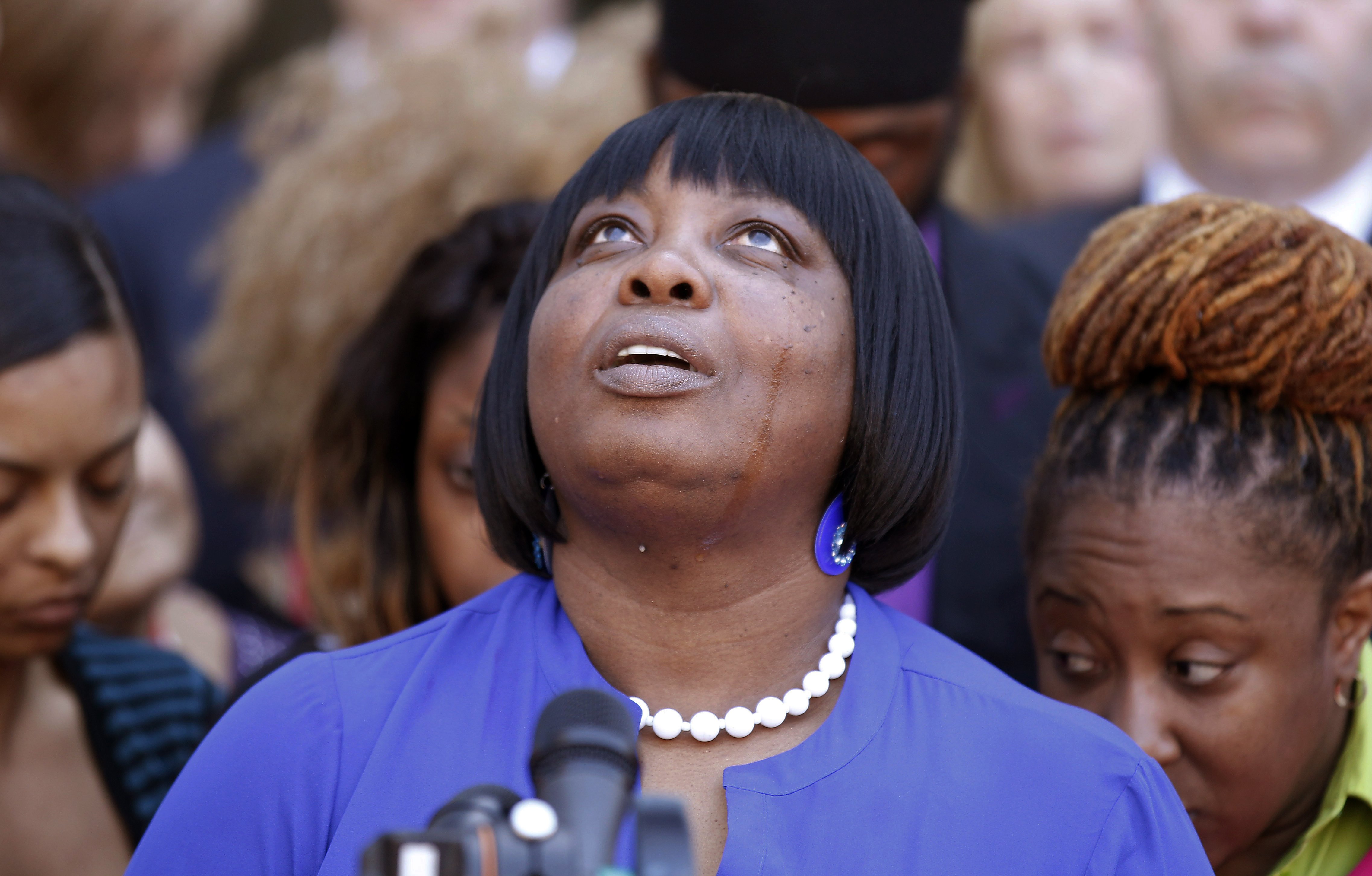 Ursula Ward, mother of shooting victim Odin Lloyd, looks up to the heavens as she talks about her deceased son outside Bristol County Superior Court on April 15, 2015, in Fall River, Mass., after former New England Patriots football player Aaron Hernandez was found guilty of murder in the shooting death of Odin Lloyd.
