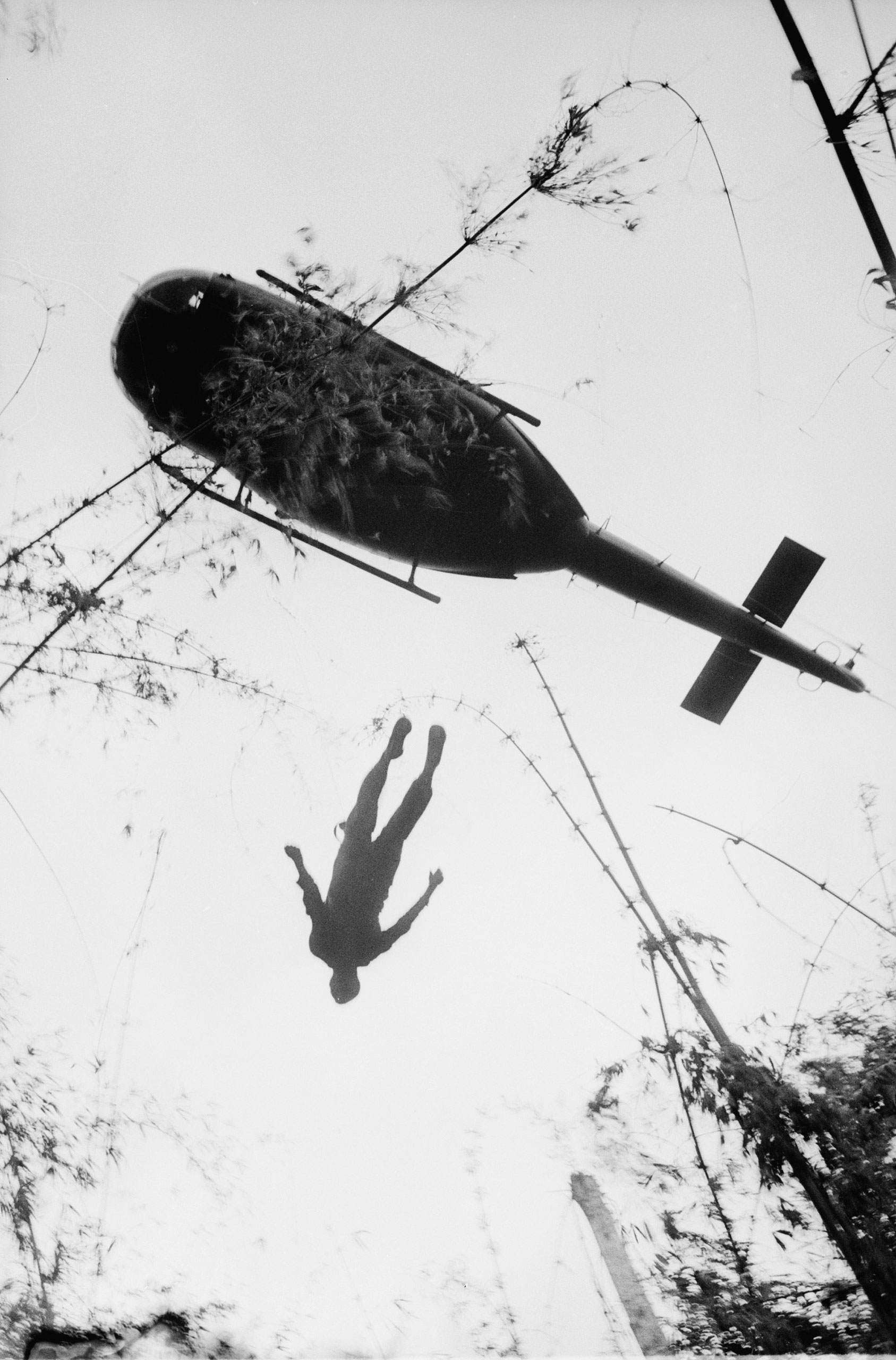 The body of an American paratrooper killed in action in the jungle near the Cambodian border is raised up to an evacuation helicopter in War Zone C in Vietnam on May 14, 1966.