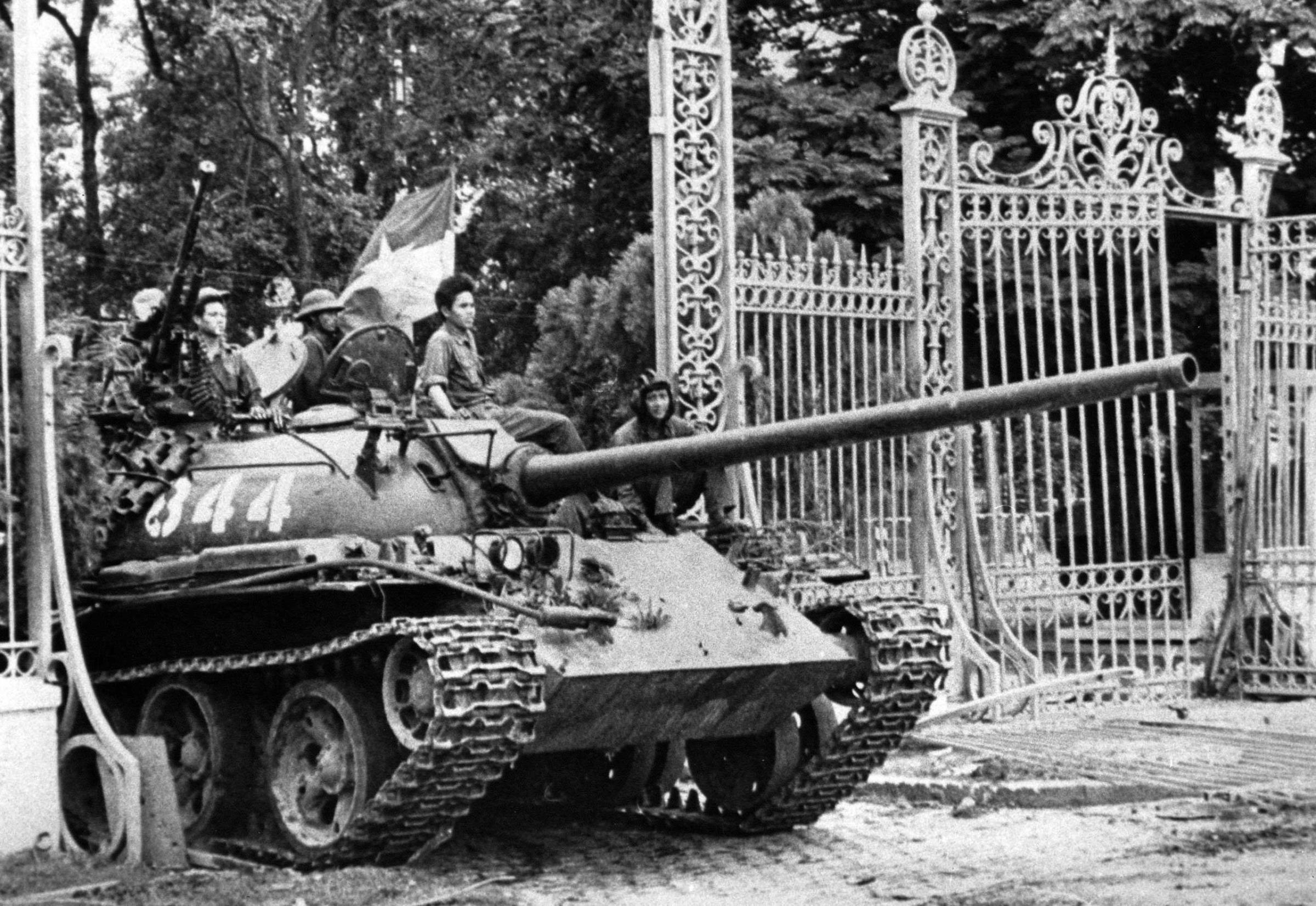 A North Vietnamese tank rolls through the gates of the Presidential Palace in Saigon, signifying the fall of South Vietnam, on April 30, 1975.
