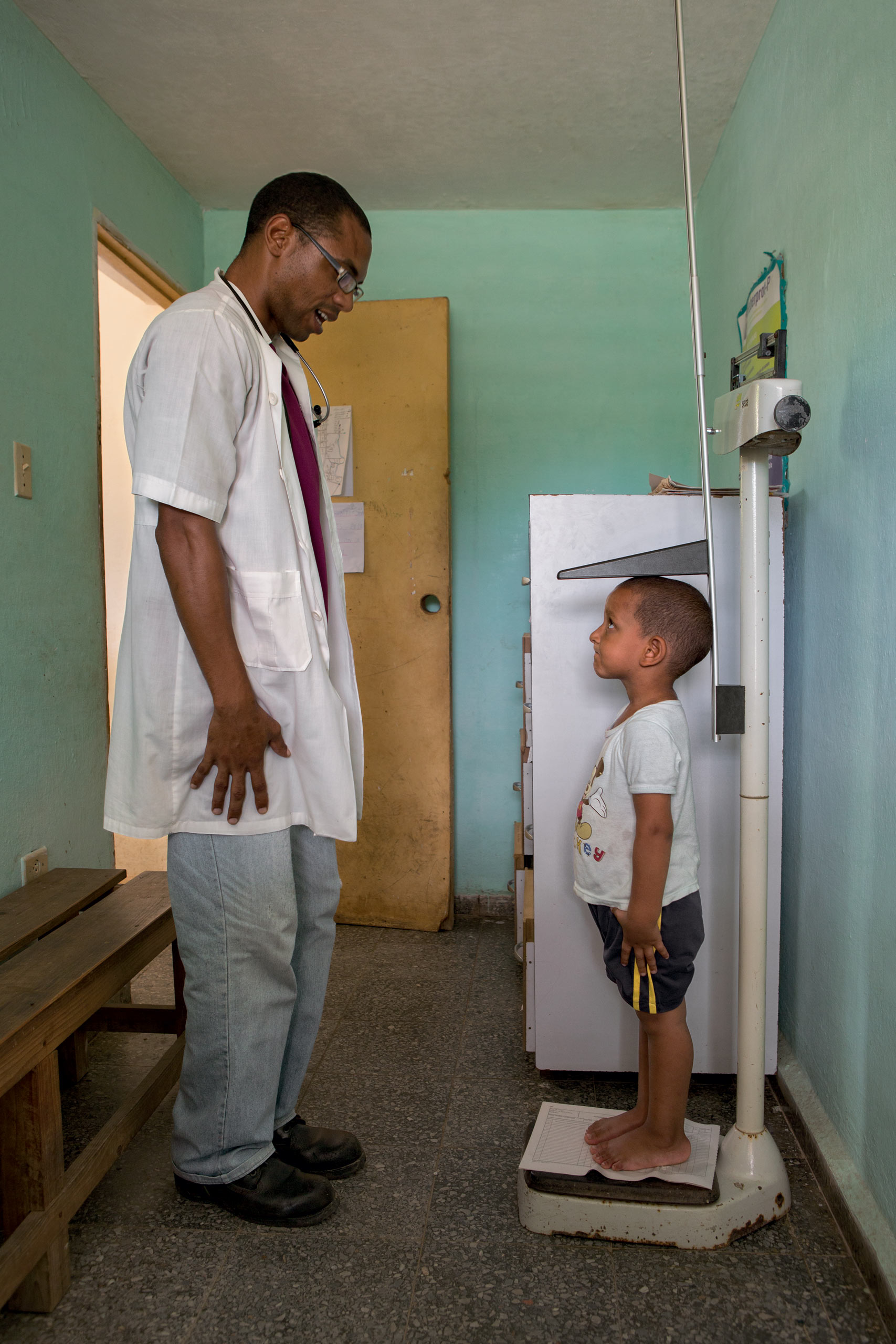 Dr. Rodriguez provides primary care to Shexley Benent, 2, at walk-in clinic Number 14 at La Santa Fe, Isle of Youth, Cuba.