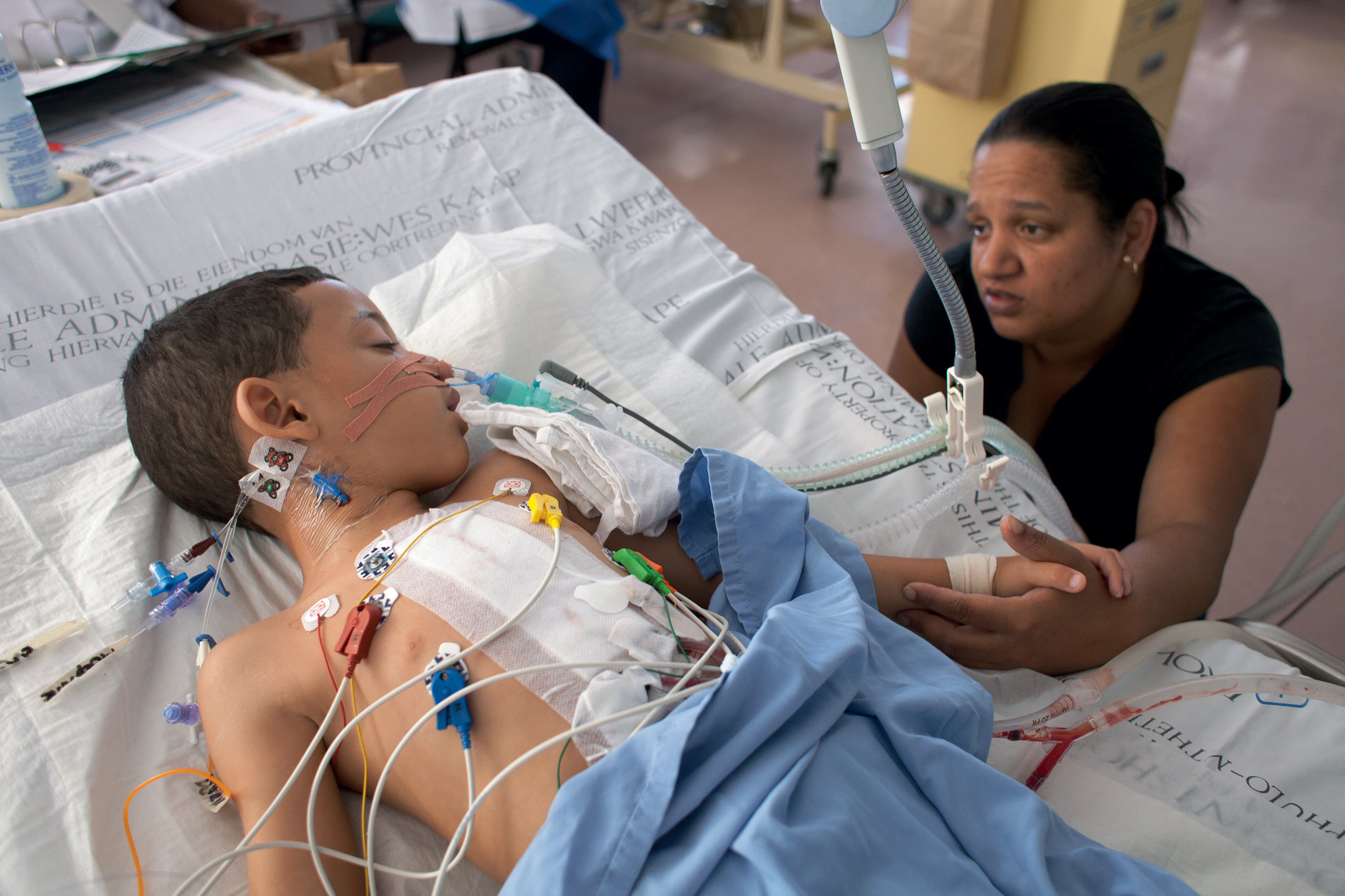 Tristan Adams with his mother as he wakes up after major heart surgery in the Paediatric Intensive Care Unit of The Red Cross War Memorial Children’s Hospital, in South Africa. In 2009, an Atlantic grant contributed to the building of
                              a new operating theatre complex that includes eight fully equipped operating rooms.