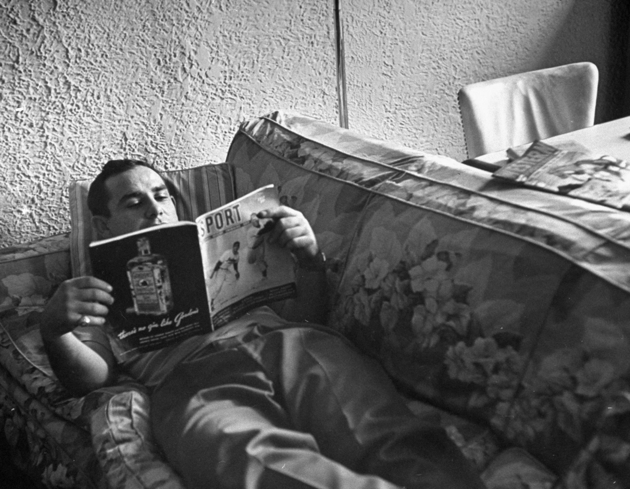 Yogi relaxes with type of reading he likes next best to comic books. He once asked a teammate studying a medical textbook, "How did it come out?"