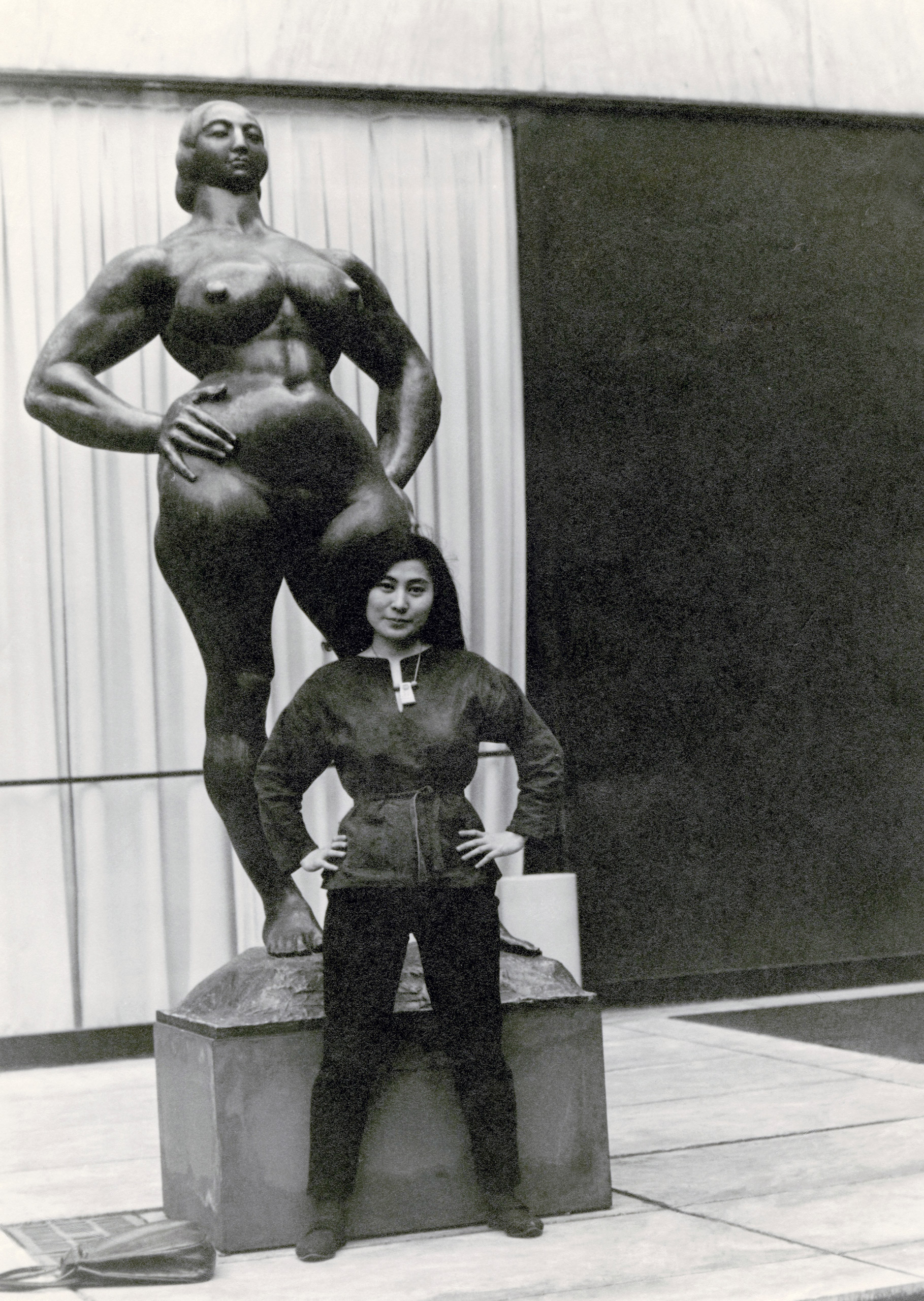 Yoko Ono with Standing Woman (1932) by Gaston Lachaise, The Museum of Modern Art Sculpture Garden, New York. c. 1960–61. (Minoru Niizuma—Courtesy Lenono Photo Archive, New York)