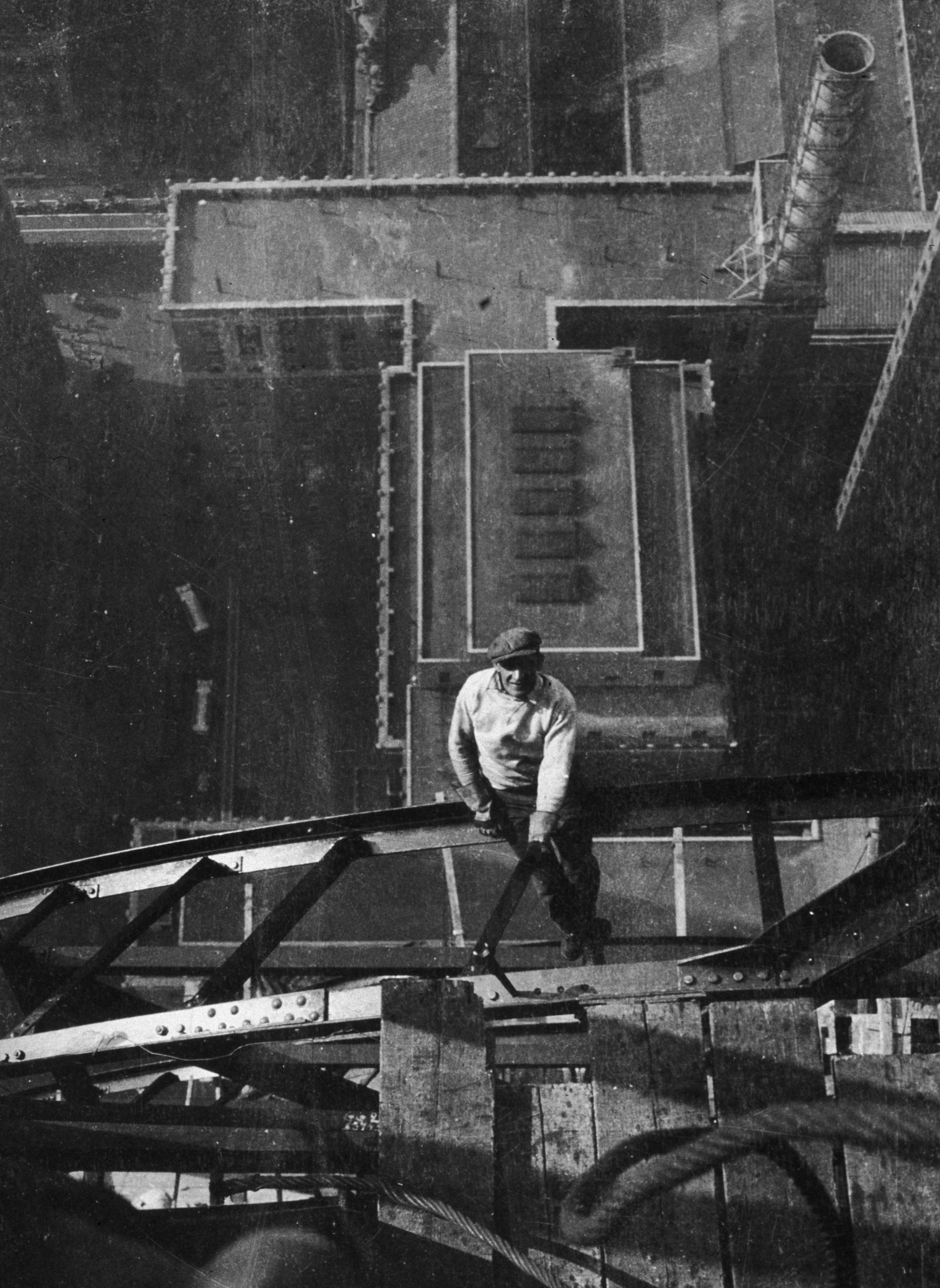 High-angle view of a worker sitting on a steel girder high atop the Chrysler Building, on the 54th floor, during its construction, New York City, 1929.