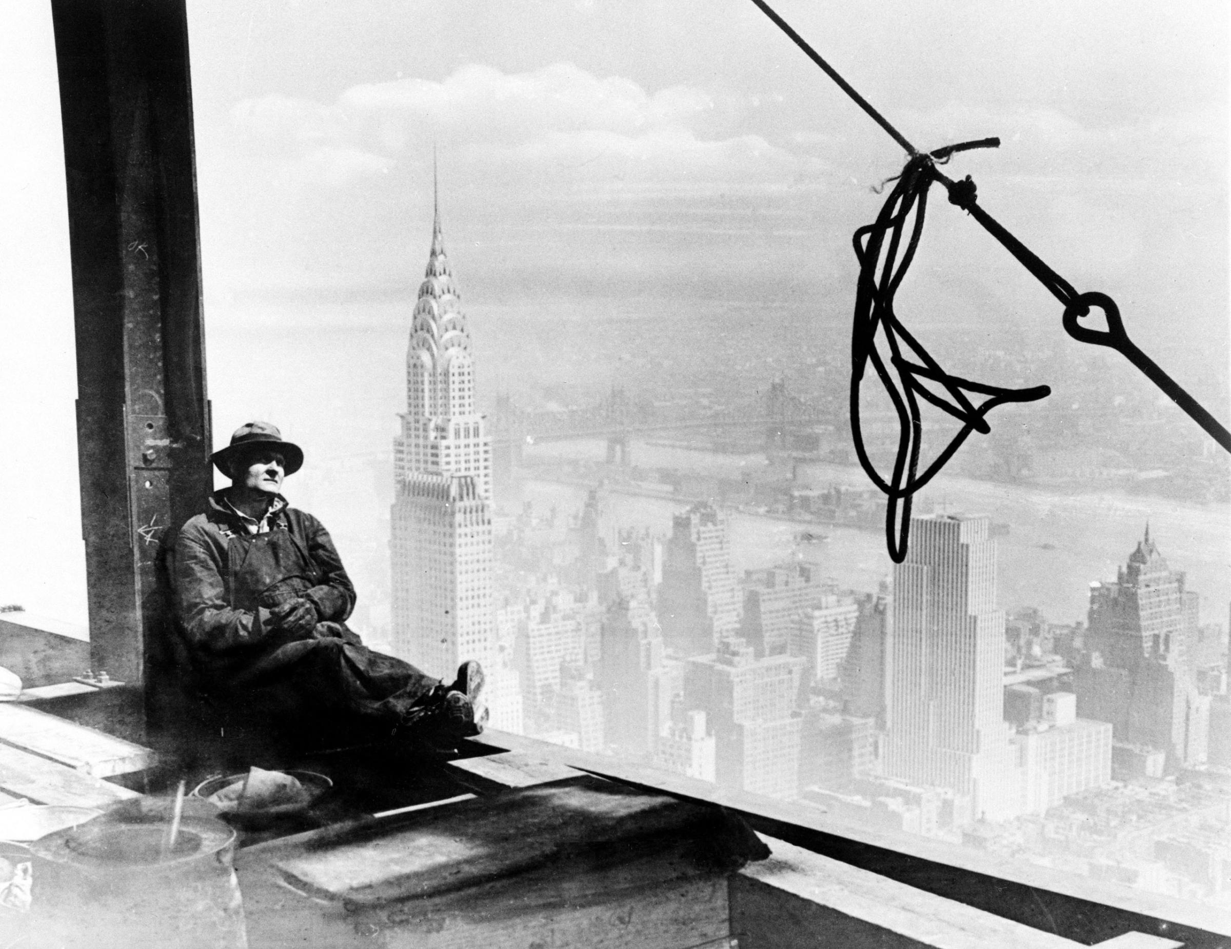 With the Chrysler Building to his left, a steel worker rests on a girder at the 86th floor of the new Empire State Building during construction in New York City, Sept. 24, 1930.
