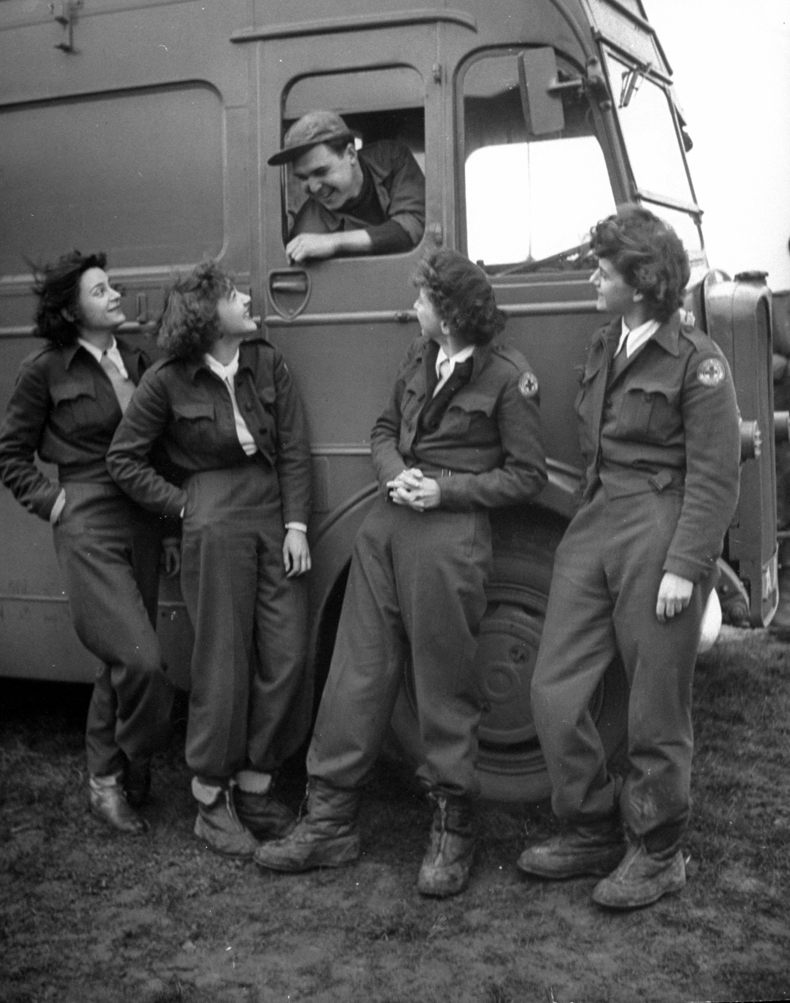Girls chat with driver, Fred Clark. Crew captain of North Dakota is Virginia Sherwood (far right). She orders food, keeps accounts, struggles with laundry problem.