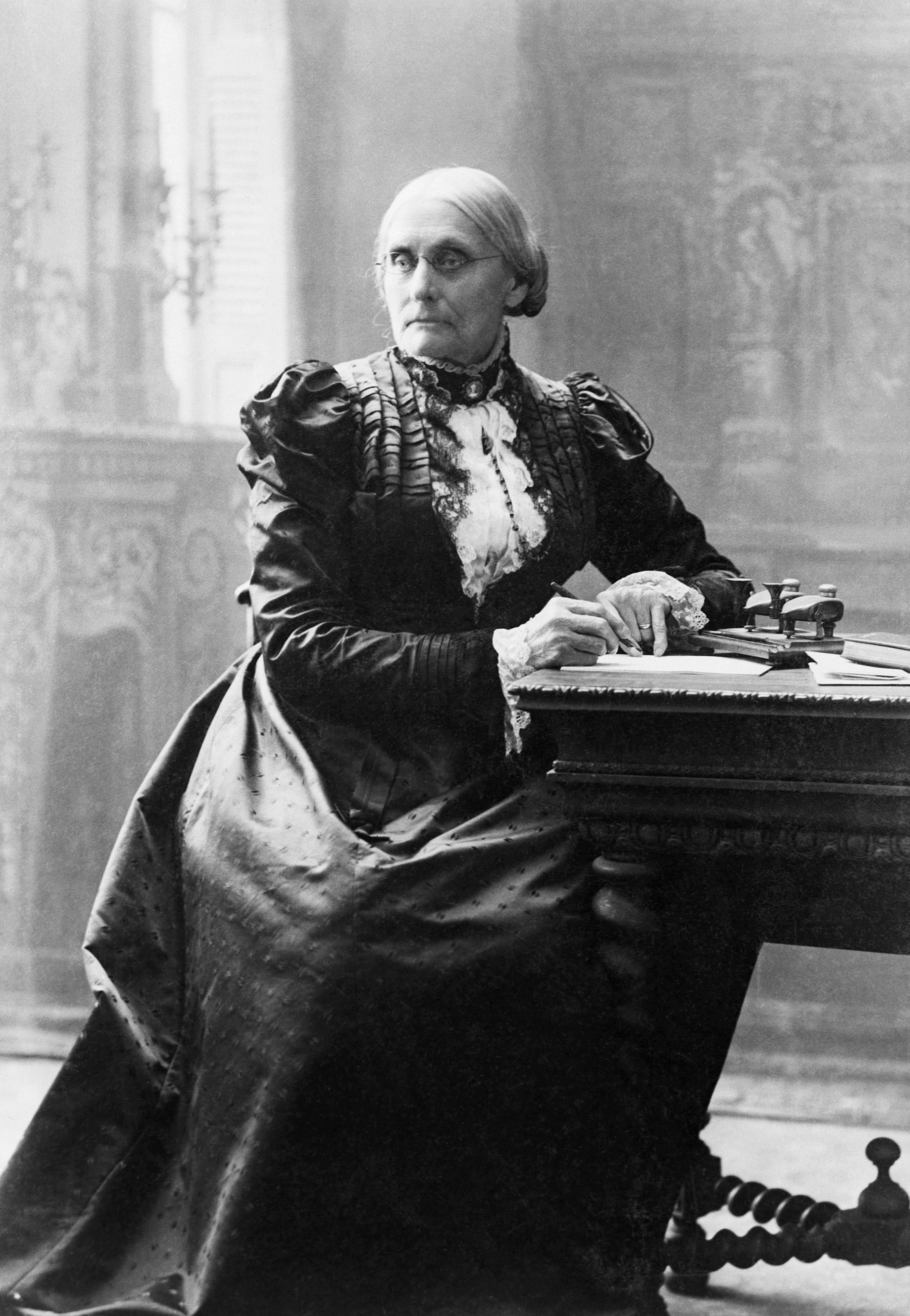 Suffragist Susan B. Anthony (1820-1906), seated at her desk, December 1898.