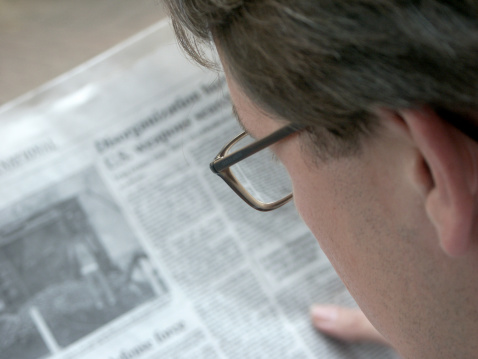 man-reading-newspaper-close-up